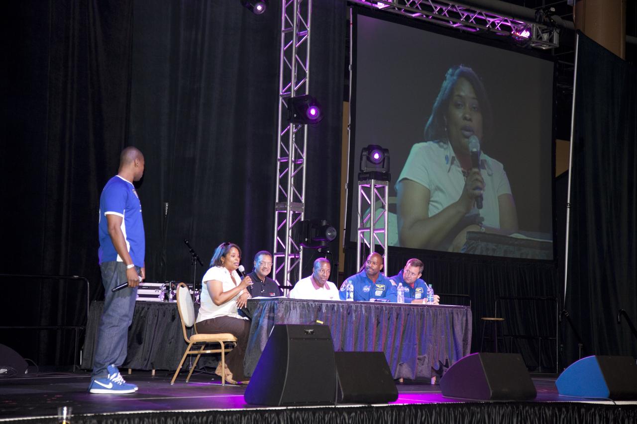 CAPE CANAVERAL, Fla. -- The NASA Legends and Trailblazers Panel address the audience attending the Tom Joyner Family Reunion. From left is the master of ceremonies, Lance Foster (standing) with panel members Robyn Gordon, director of Center Operations, Glenn Research Center; Lewis Braxton, deputy director, Ames Research Center; Woodrow Whitlow, associate administrator for Mission Support Directorates, NASA Headquarters; astronaut Leland Melvin, associate administrator for Education, NASA Headquarters; and astronaut Mike Foreman, Johnson Space Center. The event was held in the Exhibit Hall of the Gaylord Palms Resort and Convention Center in Kissimmee, Fla., and hosted by nationally syndicated radio personality Tom Joyner during the extended Labor Day weekend Sept. 1-4. Besides offering attendees the opportunity to visit tourist attractions in the Orlando area, the reunion gave NASA education specialists an avenue to tout the benefits of math and scientific learning, as well as the many educational opportunities offered by the space agency. For more information on NASA's education initiatives, visit http://www.nasa.gov/education. Photo credit: NASA/Frankie Martin