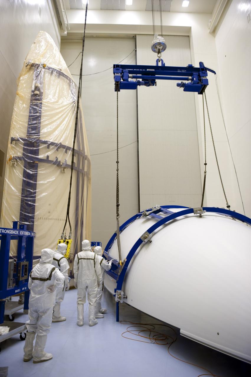 CAPE CANAVERAL, Fla. -- In the Payload Hazardous Servicing Facility at NASA's Kennedy Space Center in Florida, a lifting device is secured to half of the Atlas V payload fairing for NASA's Mars Science Laboratory (MSL) mission. The fairing has been uncovered, and preparations are under way to clean it to meet NASA's planetary protection requirements. At left is the other half of the fairing, still uncovered. The fairing will protect the spacecraft from the impact of aerodynamic pressure and heating during ascent. Although jettisoned once the spacecraft is outside the Earth's atmosphere, the fairing must be cleaned to the same exacting standards as the laboratory to avoid the possibility of contaminating it. MSL's components include a compact car-sized rover, Curiosity, which has 10 science instruments designed to search for evidence on whether Mars has had environments favorable to microbial life, including the chemical ingredients for life. The unique rover will use a laser to look inside rocks and release its gasses so that the rover’s spectrometer can analyze and send the data back to Earth. Launch of MSL aboard a United Launch Alliance Atlas V rocket is planned for Nov. 25 from Space Launch Complex 41 on Cape Canaveral Air Force Station. For more information, visit http://www.nasa.gov/msl. Photo credit: NASA/Kim Shiflett