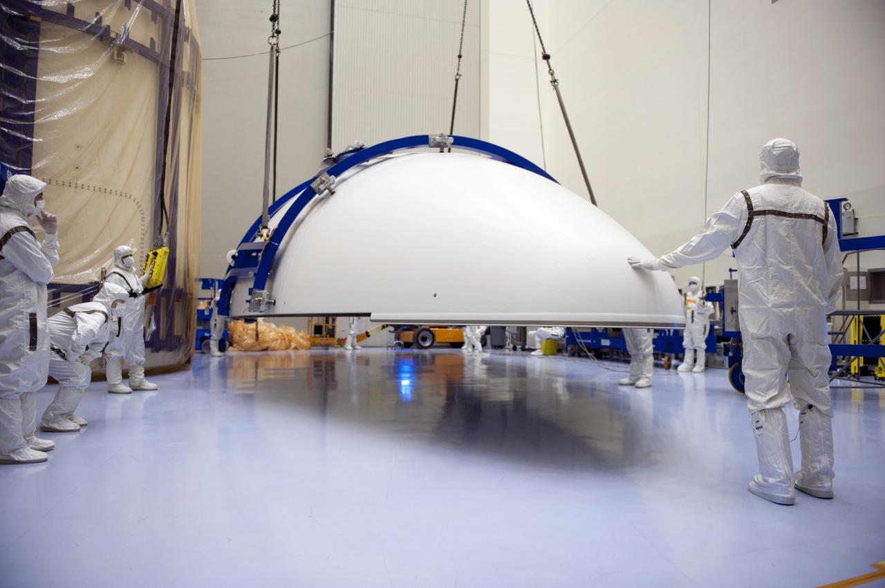CAPE CANAVERAL, Fla. -- In the Payload Hazardous Servicing Facility at NASA's Kennedy Space Center in Florida, half of the Atlas V payload fairing for NASA's Mars Science Laboratory (MSL) mission hovers above the floor during operations to raise it into a vertical position. The fairing has been uncovered, and preparations are under way to clean it to meet NASA's planetary protection requirements. At left is the other half of the fairing, still uncovered. The fairing will protect the spacecraft from the impact of aerodynamic pressure and heating during ascent. Although jettisoned once the spacecraft is outside the Earth's atmosphere, the fairing must be cleaned to the same exacting standards as the laboratory to avoid the possibility of contaminating it. MSL's components include a compact car-sized rover, Curiosity, which has 10 science instruments designed to search for evidence on whether Mars has had environments favorable to microbial life, including the chemical ingredients for life. The unique rover will use a laser to look inside rocks and release its gasses so that the rover’s spectrometer can analyze and send the data back to Earth. Launch of MSL aboard a United Launch Alliance Atlas V rocket is planned for Nov. 25 from Space Launch Complex 41 on Cape Canaveral Air Force Station. For more information, visit http://www.nasa.gov/msl. Photo credit: NASA/Kim Shiflett