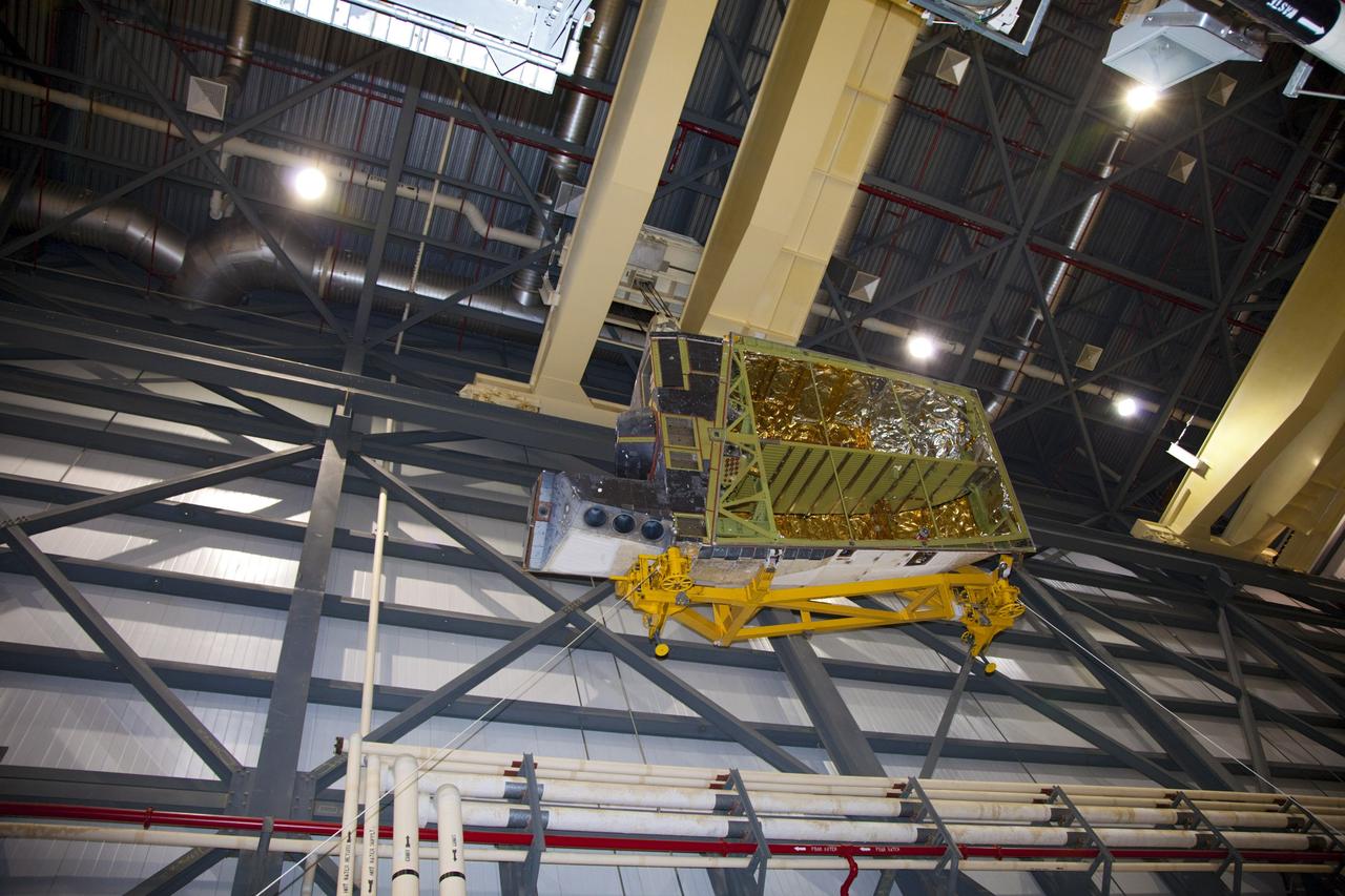 CAPE CANAVERAL, Fla. – In Orbiter Processing Facility-1 at NASA’s Kennedy Space Center in Florida, a crane carries an orbital maneuvering system (OMS) pod that will be installed on space shuttle Discovery.      The OMS pod was returned from White Sands Space Harbor in New Mexico where it underwent a complete deservicing and cleaning. The work is part of the Space Shuttle Program’s transition and retirement processing of space shuttle Discovery. The shuttle will go to the Smithsonian’s National Air and Space Museum, Steven F. Udvar-Hazy Center in Chantilly, Va., in April 2012. For more information, visit http://www.nasa.gov/shuttle.  Photo credit: NASA/Frankie Martin