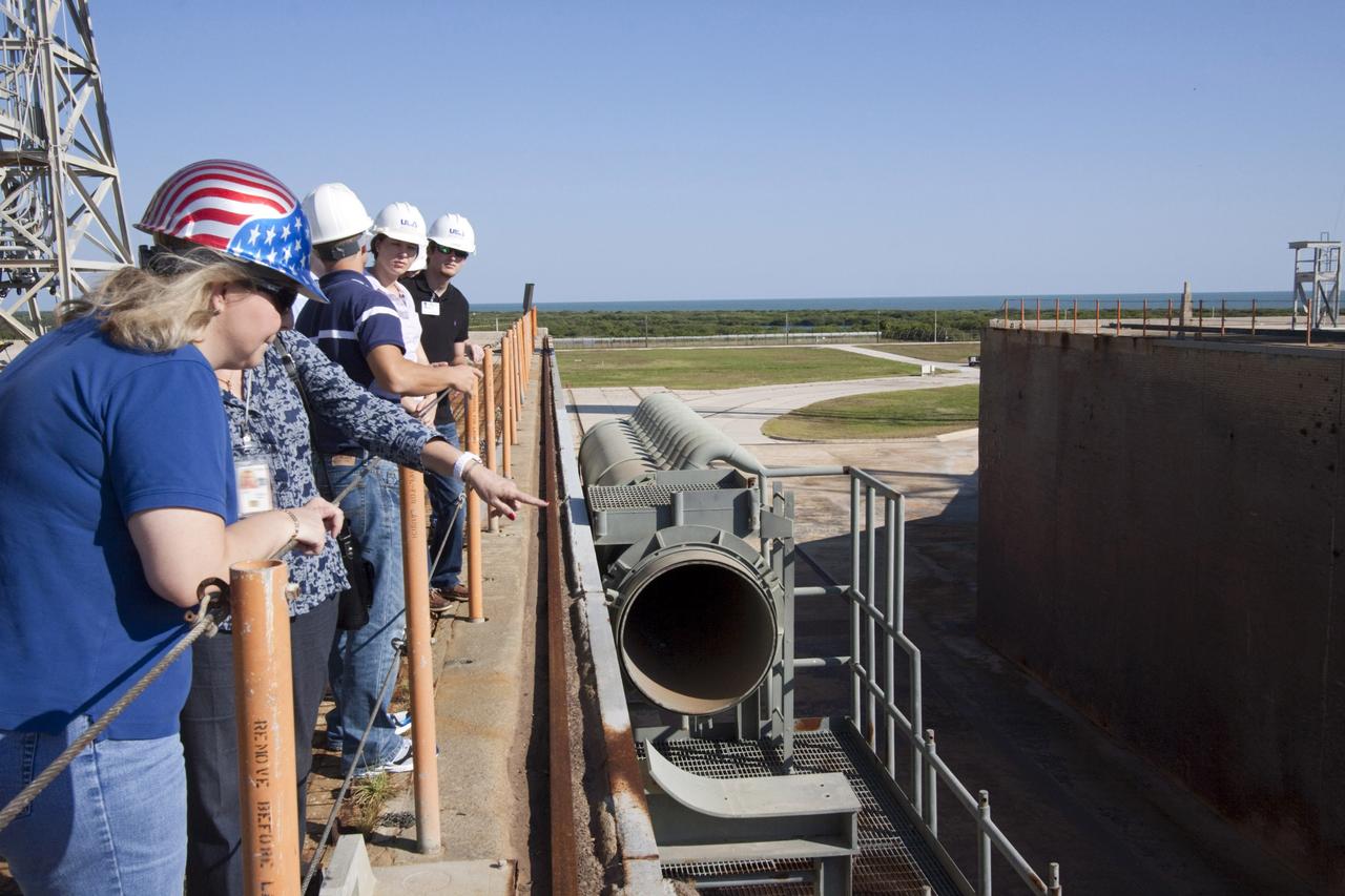 CAPE CANAVERAL, Fla. – Mechanical engineering students from Louisiana State University joined engineers and scientists at Launch Pad 39B at NASA's Kennedy Space Center in Florida as the students toured the facility to have a look at the flame trench. Designers are looking for new, flame and vibration-resistant materials to line the trench. To help in the search, a team of mechanical engineering students at Louisiana State University are to build a scaled-down version of the flame trench that Kennedy's scientists can use to try out sample materials for the trench. If the samples work in the lab, they can be tried out in the real flame trenches at Launch Pad 39A and 39B.    The launch pad has been refurbished extensively and work is continuing to modify the pad to support a variety of launch vehicles in the future. Photo credit: NASA/Jim Grossmann