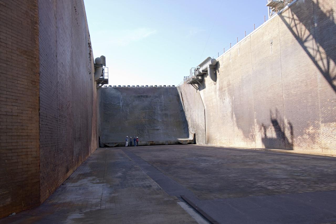 CAPE CANAVERAL, Fla. – The flame trench at Launch Pad 39B at NASA's Kennedy Space Center in Florida endured significant flames, vibrations and other stresses during the space shuttle era. Heading into the future, designers are looking for new, flame and vibration-resistant materials to line the trench. To help in the search, a team of mechanical engineering students at Louisiana State University are to build a scaled-down version of the flame trench that Kennedy's scientists can use to try out sample materials for the trench. If the samples work in the lab, they can be tried out in the real flame trenches at Launch Pad 39A and 39B.    The launch pad has been refurbished extensively and work is continuing to modify the pad to support a variety of launch vehicles in the future. Photo credit: NASA/Jim Grossmann