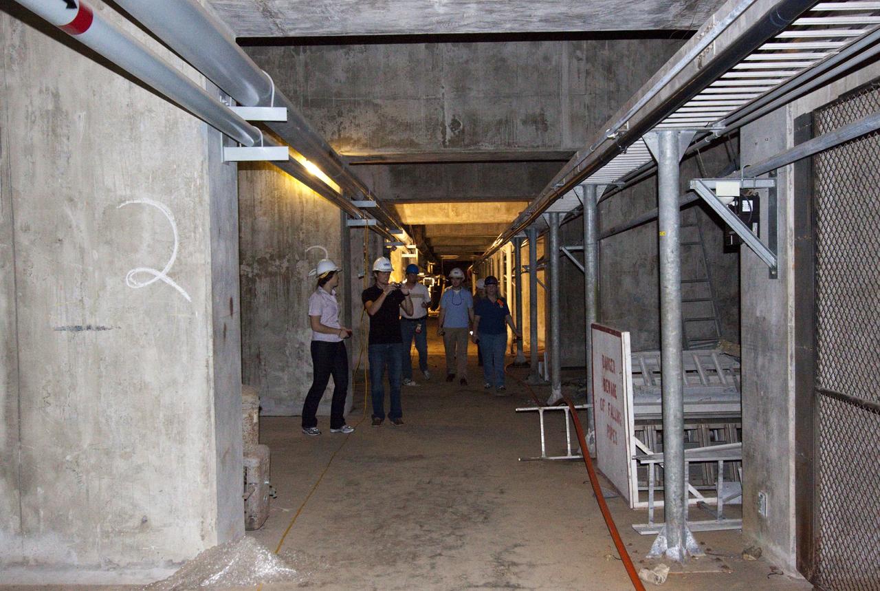 CAPE CANAVERAL, Fla. – Mechanical engineering students from Louisiana State University joined engineers and scientists at Launch Pad 39B at NASA's Kennedy Space Center in Florida as the students toured the facility to have a look at the flame trench. They went inside the pad structure as part of their insight. The students signed up to help designers looking for new, flame and vibration-resistant materials to line the trench. The students are to build a scaled-down version of the flame trench that Kennedy's scientists can use to try out sample materials for the trench. If the samples work in the lab, they can be tried out in the real flame trenches at Launch Pad 39A and 39B.    The launch pad has been refurbished extensively and work is continuing to modify the pad to support a variety of launch vehicles in the future. Photo credit: NASA/Jim Grossmann