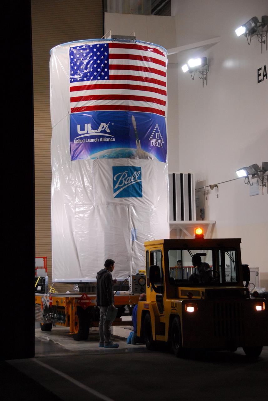 Tucked inside a protective payload transportation canister, NASA’s National Polar-orbiting Operational Environmental Satellite System Preparatory Project (NPP) spacecraft prepares to leave the Astrotech Payload Processing Facility for the launch pad.    NPP represents a critical first step in building the next-generation of Earth-observing satellites. NPP will carry the first of the new sensors developed for this satellite fleet, now known as the Joint Polar Satellite System (JPSS), to be launched in 2016. NPP is the bridge between NASA's Earth Observing System (EOS) satellites and the forthcoming series of JPSS satellites. The mission will test key technologies and instruments for the JPSS missions. NPP is targeted to launch Oct. 28 from Space Launch Complex-2 aboard a United Launch Alliance Delta II rocket. For more information, visit http://www.nasa.gov/NPP. Photo credit: NASA/VAFB