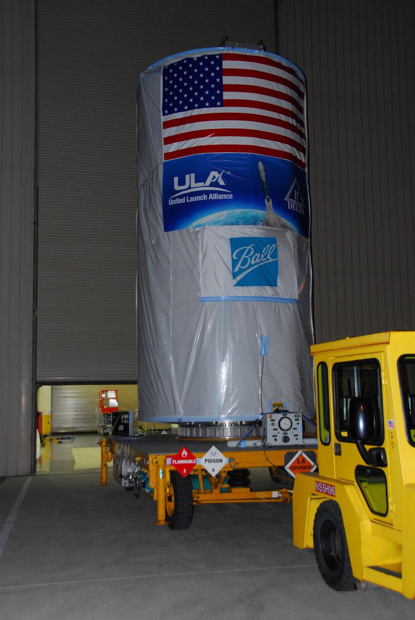 Tucked inside a protective payload transportation canister, NASA’s National Polar-orbiting Operational Environmental Satellite System Preparatory Project (NPP) spacecraft leaves the Astrotech Payload Processing Facility and heads for the launch pad.   NPP represents a critical first step in building the next-generation of Earth-observing satellites. NPP will carry the first of the new sensors developed for this satellite fleet, now known as the Joint Polar Satellite System (JPSS), to be launched in 2016. NPP is the bridge between NASA's Earth Observing System (EOS) satellites and the forthcoming series of JPSS satellites. The mission will test key technologies and instruments for the JPSS missions. NPP is targeted to launch Oct. 28 from Space Launch Complex-2 aboard a United Launch Alliance Delta II rocket. For more information, visit http://www.nasa.gov/NPP. Photo credit: NASA/VAFB