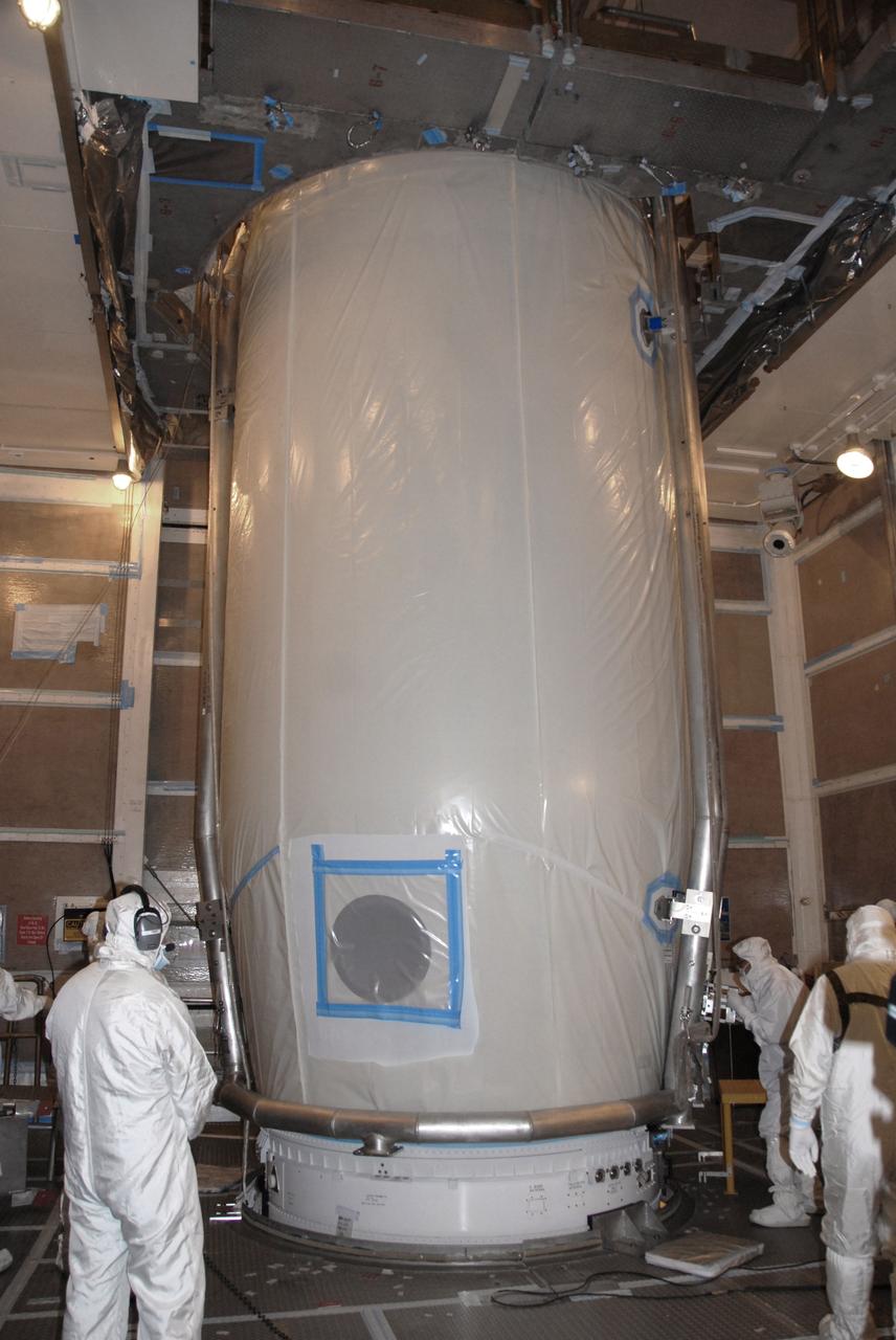 VANDENBERG AIR FORCE BASE, Calif. – At Vandenberg Air Force Base's Space Launch Complex-2 in California, technicians make final inspections of the clamshell-shaped Delta payload fairing for NASA’s National Polar-orbiting Operational Environmental Satellite System Preparatory Project (NPP) spacecraft after encapsulation. The fairing will protect the spacecraft from the impact of aerodynamic pressure and heating during ascent and will be jettisoned once the spacecraft is outside the Earth's atmosphere.    NPP represents a critical first step in building the next-generation of Earth-observing satellites. NPP will carry the first of the new sensors developed for this satellite fleet, now known as the Joint Polar Satellite System (JPSS) to be launched in 2016. NPP is the bridge between NASA's Earth Observing System (EOS) satellites and the forthcoming series of JPSS satellites. The mission will test key technologies and instruments for the JPSS missions. NPP is targeted to launch Oct. 28 from Space Launch Complex-2 aboard a United Launch Alliance Delta II rocket. For more information, visit http://www.nasa.gov/NPP. Photo credit: NASA/Mark P. Mackley, VAFB