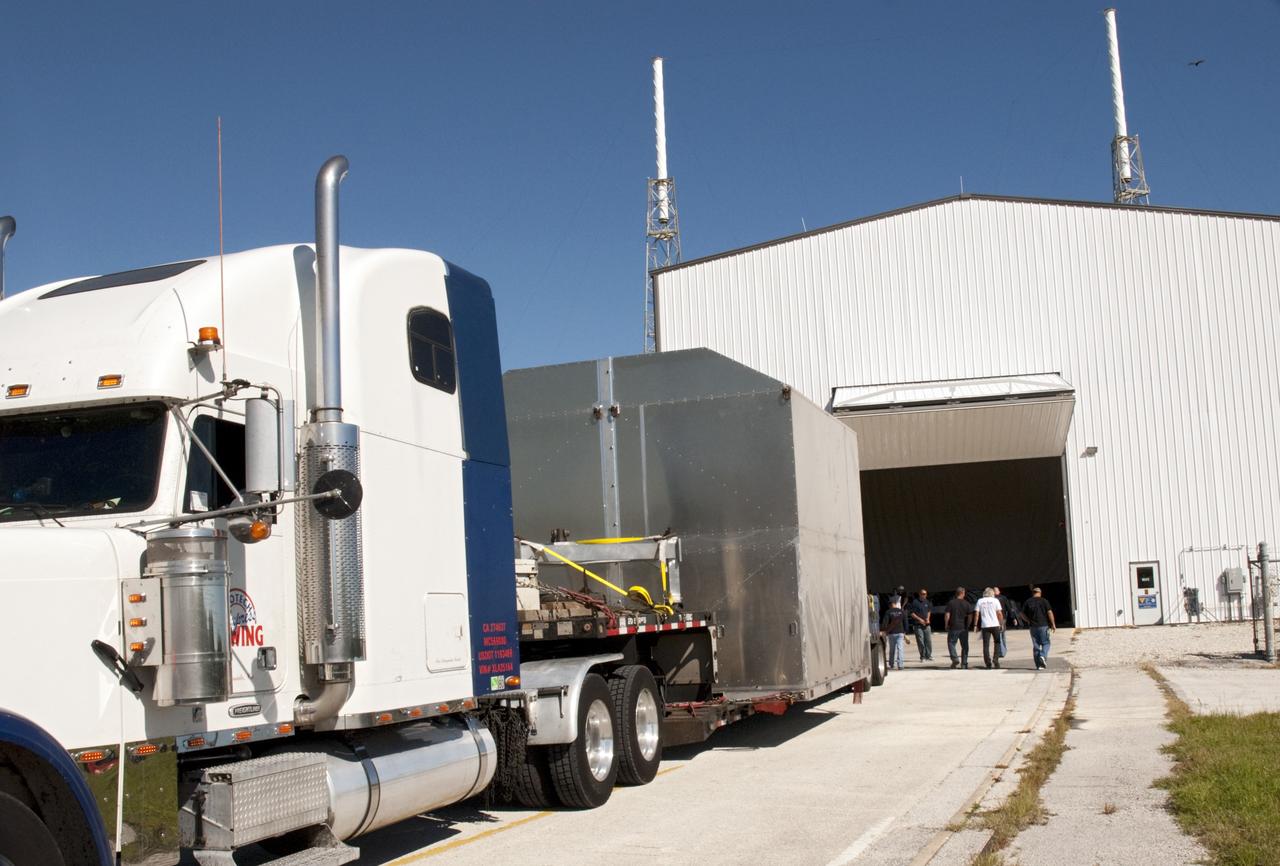 A truck carries the latest Space Exploration Technologies Corp. (SpaceX) Dragon capsule to Cape Canaveral Air Force Station in Florida on Oct. 23 so it can be processed and attached to the top of a Falcon 9 rocket on Space Launch Complex-40 for the company's next demonstration test flight for NASA's Commercial Orbital Transportation Services (COTS) program.    SpaceX is one of two companies under contract with NASA to take cargo to the International Space Station. NASA is working with SpaceX to combine its last two demonstration flights, and if approved, the Falcon 9 rocket would launch the Dragon capsule to the orbiting laboratory for a docking within the next several months. Photo credit: NASA/ Charisse Nahser