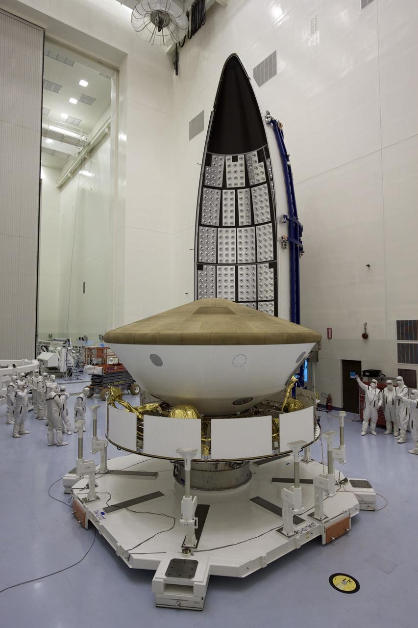 CAPE CANAVERAL, Fla. -- In the Payload Hazardous Servicing Facility at NASA's Kennedy Space Center in Florida, spacecraft technicians prepare to enclose NASA's Mars Science Laboratory (MSL) in an Atlas V rocket payload fairing. The blocks on the interior of the fairing are components of the fairing acoustic protection (FAP) system, designed to protect the payload by dampening the sound created by the rocket during liftoff. The fairing will protect the spacecraft from the impact of aerodynamic pressure and heating during ascent. MSL's components include a compact car-sized rover, Curiosity, which has 10 science instruments designed to search for evidence on whether Mars has had environments favorable to microbial life, including the chemical ingredients for life. The unique rover will use a laser to look inside rocks and release its gasses so that the rover’s spectrometer can analyze and send the data back to Earth. Launch of MSL aboard a United Launch Alliance Atlas V rocket is planned for Nov. 25 from Space Launch Complex-41 on Cape Canaveral Air Force Station. For more information, visit http://www.nasa.gov/msl. Photo credit: NASA/Jim Grossmann