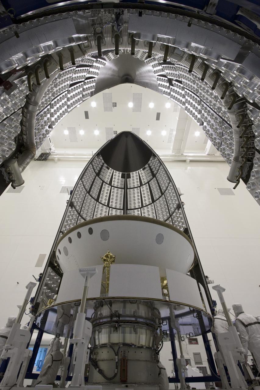 CAPE CANAVERAL, Fla. -- In the Payload Hazardous Servicing Facility at NASA's Kennedy Space Center in Florida, sections of an Atlas V rocket payload fairing engulf NASA's Mars Science Laboratory (MSL) as they close in around it. The blocks on the interior of the fairing are components of the fairing acoustic protection (FAP) system, designed to protect the payload by dampening the sound created by the rocket during liftoff. The fairing will protect the spacecraft from the impact of aerodynamic pressure and heating during ascent. MSL's components include a compact car-sized rover, Curiosity, which has 10 science instruments designed to search for evidence on whether Mars has had environments favorable to microbial life, including the chemical ingredients for life. The unique rover will use a laser to look inside rocks and release its gasses so that the rover’s spectrometer can analyze and send the data back to Earth. Launch of MSL aboard a United Launch Alliance Atlas V rocket is planned for Nov. 25 from Space Launch Complex-41 on Cape Canaveral Air Force Station. For more information, visit http://www.nasa.gov/msl. Photo credit: NASA/Jim Grossmann