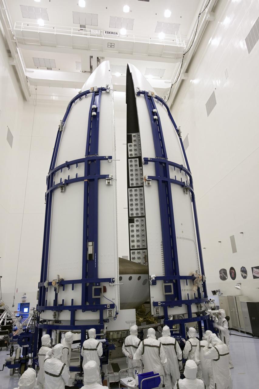 CAPE CANAVERAL, Fla. -- In the Payload Hazardous Servicing Facility at NASA's Kennedy Space Center in Florida, sections of an Atlas V rocket payload fairing obscure NASA's Mars Science Laboratory (MSL) from view as they close in around it. The blocks on the interior of the fairing are components of the fairing acoustic protection (FAP) system, designed to protect the payload by dampening the sound created by the rocket during liftoff. The fairing will protect the spacecraft from the impact of aerodynamic pressure and heating during ascent. MSL's components include a compact car-sized rover, Curiosity, which has 10 science instruments designed to search for evidence on whether Mars has had environments favorable to microbial life, including the chemical ingredients for life. The unique rover will use a laser to look inside rocks and release its gasses so that the rover’s spectrometer can analyze and send the data back to Earth. Launch of MSL aboard a United Launch Alliance Atlas V rocket is planned for Nov. 25 from Space Launch Complex-41 on Cape Canaveral Air Force Station. For more information, visit http://www.nasa.gov/msl. Photo credit: NASA/Jim Grossmann