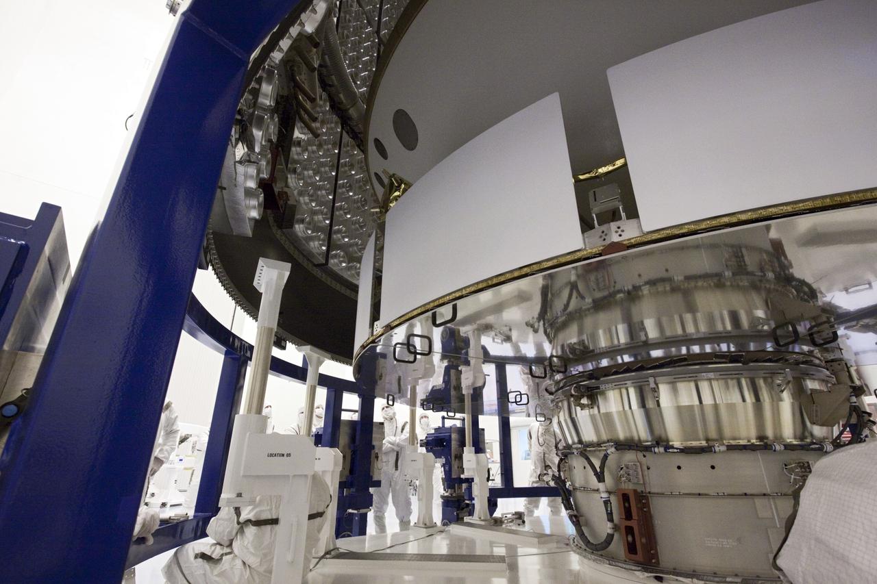 CAPE CANAVERAL, Fla. - In the Payload Hazardous Servicing Facility at NASA's Kennedy Space Center in Florida, the camera captures NASA's Mars Science Laboratory (MSL) one last time before an Atlas V rocket payload fairing is secured around it. Next, the lab will be transported to the launch pad. by dampening the sound created by the rocket during liftoff. The fairing will protect the spacecraft from the impact of aerodynamic pressure and heating during ascent. MSL's components include a compact car-sized rover, Curiosity, which has 10 science instruments designed to search for evidence on whether Mars has had environments favorable to microbial life, including the chemical ingredients for life. The unique rover will use a laser to look inside rocks and release its gasses so that the rover’s spectrometer can analyze and send the data back to Earth. Launch of MSL aboard a United Launch Alliance Atlas V rocket is planned for Nov. 25 from Space Launch Complex-41 on Cape Canaveral Air Force Station. For more information, visit http://www.nasa.gov/msl. Photo credit: NASA/Jim Grossmann