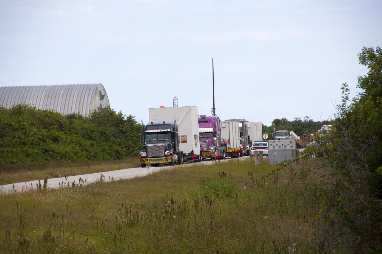 CAPE CANAVERAL, Fla. – Outside the Hazardous Maintenance Facility at NASA's Kennedy Space Center in Florida, space shuttle Endeavour’s left and right orbital maneuvering system (OMS) pods and forward reaction control system (FRCS) are secured in several containers and ready for transport to White Sands Space Harbor in New Mexico.     The work is part of the Space Shuttle Program’s transition and retirement processing of shuttle Endeavour. At White Sands the OMS pods and FRCS will undergo a complete deservicing and cleaning and then be returned to Kennedy for reinstallation on Endeavour. Endeavour is being prepared for display at the California Science Center in Los Angeles.  Photo credit: NASA/Jim Grossmann