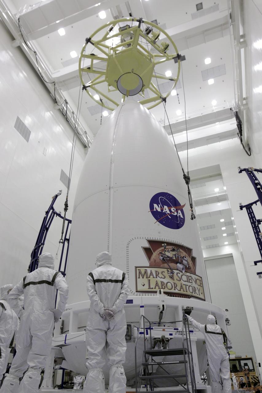 CAPE CANAVERAL, Fla. -- In the Payload Hazardous Servicing Facility at NASA's Kennedy Space Center in Florida, technicians attach a lifting device to the payload fairing of an Atlas V rocket. The fairing must be raised in order to be placed on a transporter for the move to Space Launch Complex 41. The Mars Science Laboratory (MSL) spacecraft is enclosed in the fairing, which will protect the payload from heat and aerodynamic pressure generated during launch. MSL's components include a compact car-sized rover, Curiosity, which has 10 science instruments designed to search for evidence on whether Mars has had environments favorable to microbial life, including the chemical ingredients for life. The unique rover will use a laser to look inside rocks and release its gasses so that the rover’s spectrometer can analyze and send the data back to Earth. Launch of MSL aboard a United Launch Alliance Atlas V rocket is planned for Nov. 25 from Space Launch Complex-41 on Cape Canaveral Air Force Station. For more information, visit http://www.nasa.gov/msl. Photo credit: NASA/Kim Shiflett