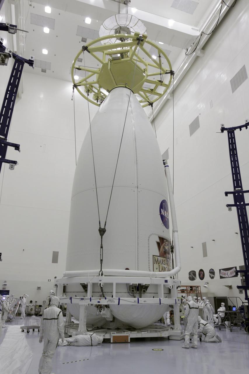 CAPE CANAVERAL, Fla. -- Technicians inside NASA Kennedy Space Center's Payload Hazardous Servicing Facility have attached a lifting device to the Atlas V rocket's payload fairing enclosing the Mars Science Laboratory (MSL) spacecraft. The fairing must be raised in order to be placed on a transporter for the move to Space Launch Complex 41. MSL's components include a compact car-sized rover, Curiosity, which has 10 science instruments designed to search for evidence on whether Mars has had environments favorable to microbial life, including the chemical ingredients for life. The unique rover will use a laser to look inside rocks and release its gasses so that the rover’s spectrometer can analyze and send the data back to Earth. Launch of MSL aboard a United Launch Alliance Atlas V rocket is planned for Nov. 25 from Space Launch Complex-41 on Cape Canaveral Air Force Station. For more information, visit http://www.nasa.gov/msl. Photo credit: NASA/Kim Shiflett
