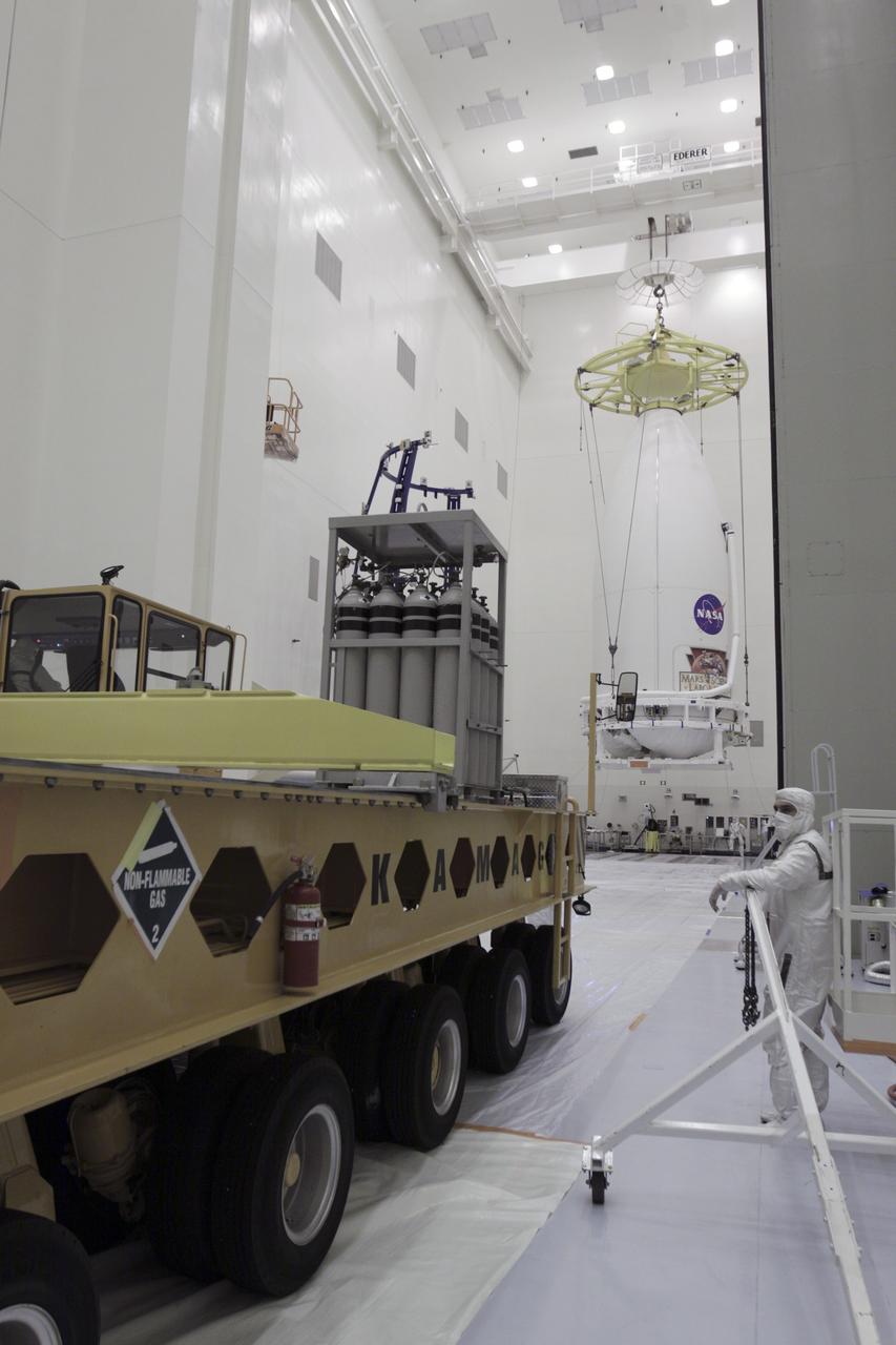CAPE CANAVERAL, Fla. -- The Atlas V payload fairing containing NASA's Mars Science Laboratory (MSL) spacecraft is moved toward a waiting transporter inside the Payload Hazardous Servicing Facility at Kennedy Space Center in Florida. The transporter will carry the fairing to Space Launch Complex 41. MSL's components include a compact car-sized rover, Curiosity, which has 10 science instruments designed to search for evidence on whether Mars has had environments favorable to microbial life, including the chemical ingredients for life. The unique rover will use a laser to look inside rocks and release its gasses so that the rover’s spectrometer can analyze and send the data back to Earth. Launch of MSL aboard a United Launch Alliance Atlas V rocket is planned for Nov. 25 from Space Launch Complex-41 on Cape Canaveral Air Force Station. For more information, visit http://www.nasa.gov/msl. Photo credit: NASA/Kim Shiflett