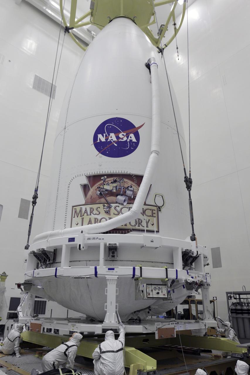 CAPE CANAVERAL, Fla. -- Technicians in the Payload Hazardous Servicing Facility at NASA's Kennedy Space Center in Florida check the placement of Atlas V rocket's payload fairing atop the transporter that will carry it to Space Launch Complex 41. The Mars Science Laboratory (MSL) spacecraft is enclosed in the fairing, which will protect the payload from heat and aerodynamic pressure generated during launch. MSL's components include a compact car-sized rover, Curiosity, which has 10 science instruments designed to search for evidence on whether Mars has had environments favorable to microbial life, including the chemical ingredients for life. The unique rover will use a laser to look inside rocks and release its gasses so that the rover’s spectrometer can analyze and send the data back to Earth. Launch of MSL aboard a United Launch Alliance Atlas V rocket is planned for Nov. 25 from Space Launch Complex-41 on Cape Canaveral Air Force Station. For more information, visit http://www.nasa.gov/msl. Photo credit: NASA/Kim Shiflett