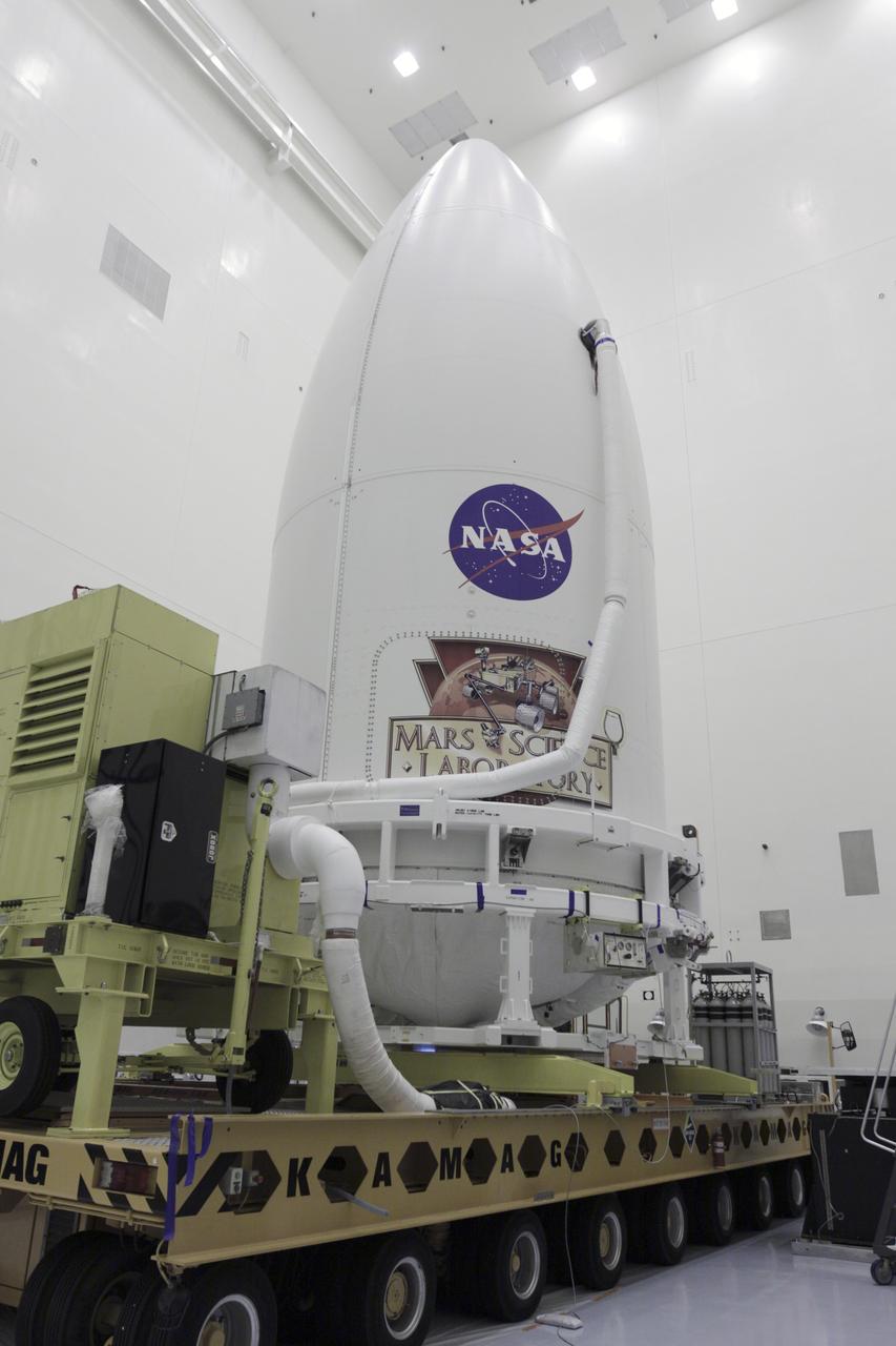 CAPE CANAVERAL, Fla. -- In the Payload Hazardous Servicing Facility at NASA's Kennedy Space Center in Florida, an Atlas V rocket's payload fairing, containing the Mars Science Laboratory (MSL) spacecraft, is in place atop a transporter that will carry it to Space Launch Complex 41. MSL's components include a compact car-sized rover, Curiosity, which has 10 science instruments designed to search for evidence on whether Mars has had environments favorable to microbial life, including the chemical ingredients for life. The unique rover will use a laser to look inside rocks and release its gasses so that the rover’s spectrometer can analyze and send the data back to Earth. Launch of MSL aboard a United Launch Alliance Atlas V rocket is planned for Nov. 25 from Space Launch Complex-41 on Cape Canaveral Air Force Station. For more information, visit http://www.nasa.gov/msl. Photo credit: NASA/Kim Shiflett