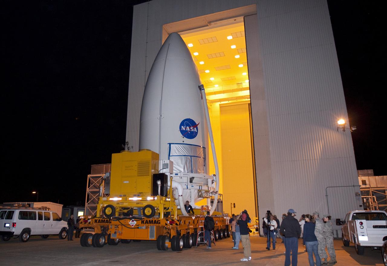 CAPE CANAVERAL, Fla. -- Standing atop a payload transporter, the Atlas V rocket payload fairing containing NASA's Mars Science Laboratory (MSL) spacecraft rolls out of the Payload Hazardous Servicing Facility at Kennedy Space Center in Florida, beginning the move to Space Launch Complex 41. The fairing will protect the payload from heat and aerodynamic pressure generated during launch. MSL's components include a compact car-sized rover, Curiosity, which has 10 science instruments designed to search for evidence on whether Mars has had environments favorable to microbial life, including the chemical ingredients for life. The unique rover will use a laser to look inside rocks and release its gasses so that the rover’s spectrometer can analyze and send the data back to Earth. Launch of MSL aboard a United Launch Alliance Atlas V rocket is planned for Nov. 25 from Space Launch Complex 41 on Cape Canaveral Air Force Station. For more information, visit http://www.nasa.gov/msl. Photo credit: NASA/Kim Shiflett