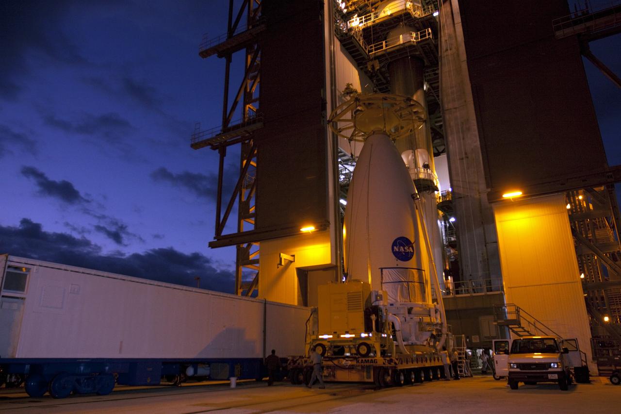 CAPE CANAVERAL, Fla. -- The predawn light reveals the payload fairing containing NASA's Mars Science Laboratory (MSL) spacecraft as it is prepared to be lifted into place atop the Atlas V rocket already waiting at the Vertical Integration Facility at Space Launch Complex 41 at Cape Canaveral Air Force Station in Florida. The fairing, which protects the payload during ascent, will be lifted and mated to the Atlas V rocket already in place at the launch pad. MSL was prepared for launch in the Payload Hazardous Servicing Facility at NASA's Kennedy Space Center. MSL's components include a compact car-sized rover, Curiosity, which has 10 science instruments designed to search for evidence on whether Mars has had environments favorable to microbial life, including the chemical ingredients for life. The unique rover will use a laser to look inside rocks and release its gasses so that the rover’s spectrometer can analyze and send the data back to Earth. Launch of MSL aboard a United Launch Alliance Atlas V rocket is planned for Nov. 25 from Space Launch Complex 41 on Cape Canaveral Air Force Station. For more information, visit http://www.nasa.gov/msl. Photo credit: NASA/Kim Shiflett