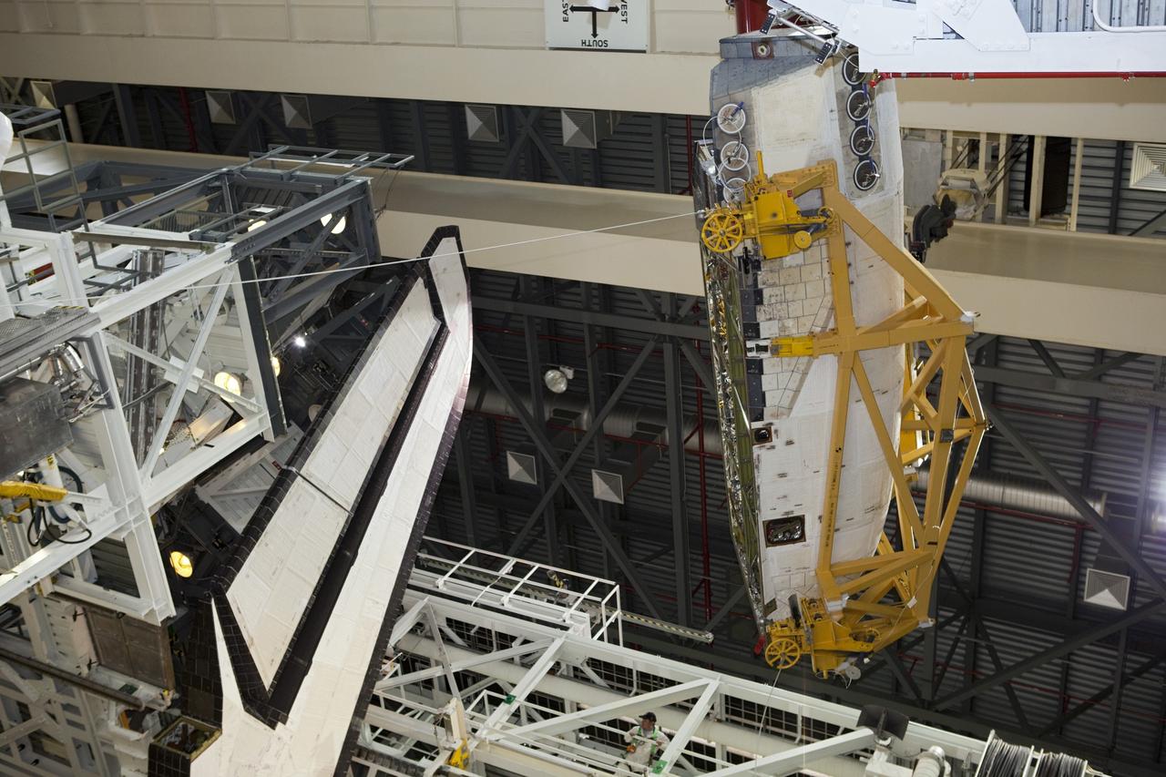CAPE CANAVERAL, Fla. – Inside Orbiter Processing Facility-2 at NASA’s Kennedy Space Center in Florida, a large crane is being used to move the right orbital maneuvering system (OMS) pod away from space shuttle Atlantis.    The work is part of the Space Shuttle Program’s transition and retirement processing of shuttle Atlantis. Both OMS pods will be removed and sent to White Sands Space Harbor in New Mexico where they will undergo a complete deservicing and cleaning and then be returned to Kennedy for reinstallation on Atlantis. Atlantis is being prepared for display at the Kennedy Space Center Visitor Complex.  Photo credit: NASA/Dimitri Gerondidakis