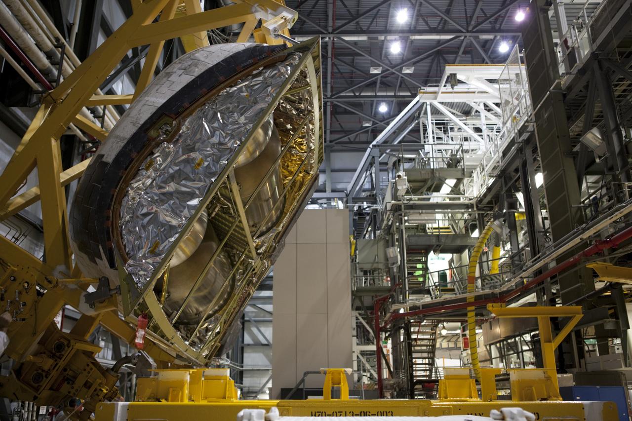CAPE CANAVERAL, Fla. – Inside Orbiter Processing Facility-2 at NASA’s Kennedy Space Center in Florida, technicians monitor the progress as a large crane lowers space shuttle Atlantis’ right orbital maneuvering system (OMS) pod onto a pallet.    The work is part of the Space Shuttle Program’s transition and retirement processing of shuttle Atlantis. Both OMS pods will be removed and sent to White Sands Space Harbor in New Mexico where they will undergo a complete deservicing and cleaning and then be returned to Kennedy for reinstallation on Atlantis. Atlantis is being prepared for display at the Kennedy Space Center Visitor Complex.  Photo credit: NASA/Dimitri Gerondidakis