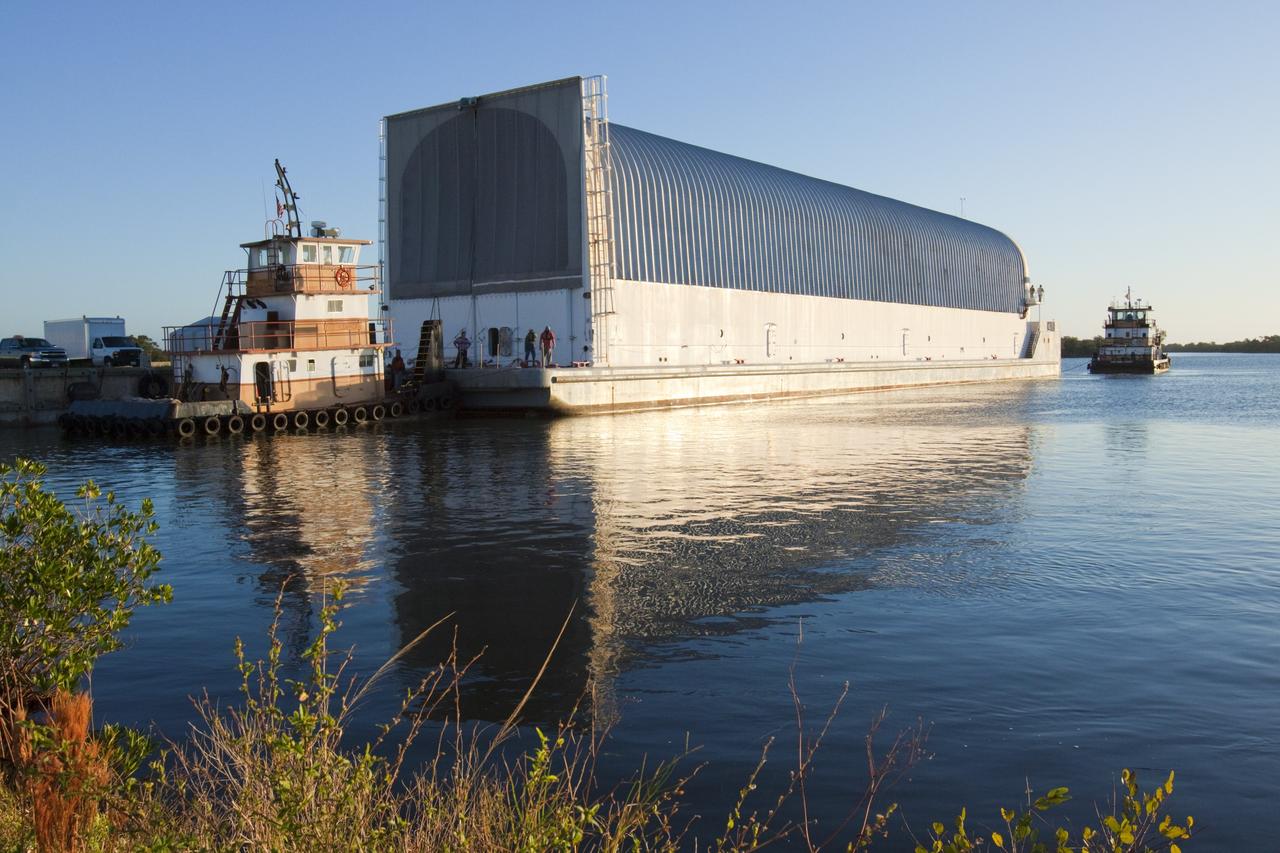 CAPE CANAVERAL, Fla. – At the Turn Basin in the Launch Complex 39 area at NASA's Kennedy Space Center in Florida, tugboats on either end of the Pegasus Barge begin to maneuver it away from the dock. The 266-foot-long and 50-foot-wide barge will be towed by NASA's Freedom Star ship to deliver space shuttle main engine (SSME) ground support equipment to Stennis Space Center near Bay St. Louis, Miss. Since being delivered to NASA in 1999, Pegasus sailed 41 times and transported 31 shuttle external fuel tanks from Michoud Assembly Facility near New Orleans to Kennedy. The barge will leave Kennedy, perhaps for the final time. Both the barge and shuttle equipment will remain in storage until their specific future uses are determined. The SSMEs themselves will be transported to Stennis separately for use with the agency’s new heavy-lift rocket, the Space Launch System. The work is part of the Space Shuttle Program’s transition and retirement processing. For more information about Shuttle Transition and Retirement, visit http://www.nasa.gov/mission_pages/transition/home/index.html. Photo credit: NASA/ Kim Shiflett
