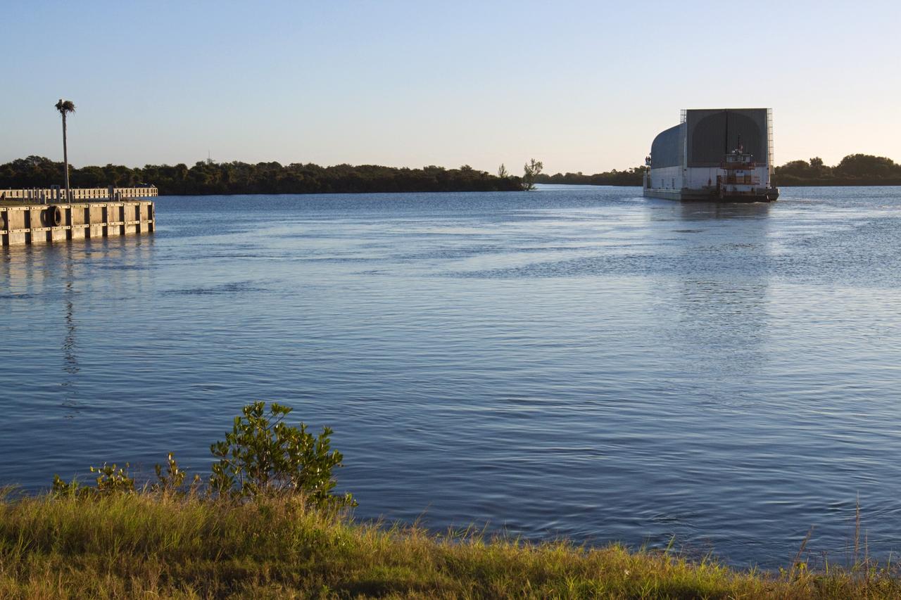 CAPE CANAVERAL, Fla. – At the Turn Basin in the Launch Complex 39 area at NASA's Kennedy Space Center in Florida, a tugboat pushes the Pegasus Barge away from the dock as it begins its journey. The 266-foot-long and 50-foot-wide barge will be towed by NASA's Freedom Star ship to deliver space shuttle main engine (SSME) ground support equipment to Stennis Space Center near Bay St. Louis, Miss. Since being delivered to NASA in 1999, Pegasus sailed 41 times and transported 31 shuttle external fuel tanks from Michoud Assembly Facility near New Orleans to Kennedy. The barge is leaving Kennedy, perhaps for the final time. Both the barge and shuttle equipment will remain in storage until their specific future uses are determined. The SSMEs themselves will be transported to Stennis separately for use with the agency’s new heavy-lift rocket, the Space Launch System. The work is part of the Space Shuttle Program’s transition and retirement processing. For more information about Shuttle Transition and Retirement, visit http://www.nasa.gov/mission_pages/transition/home/index.html. Photo credit: NASA/ Kim Shiflett