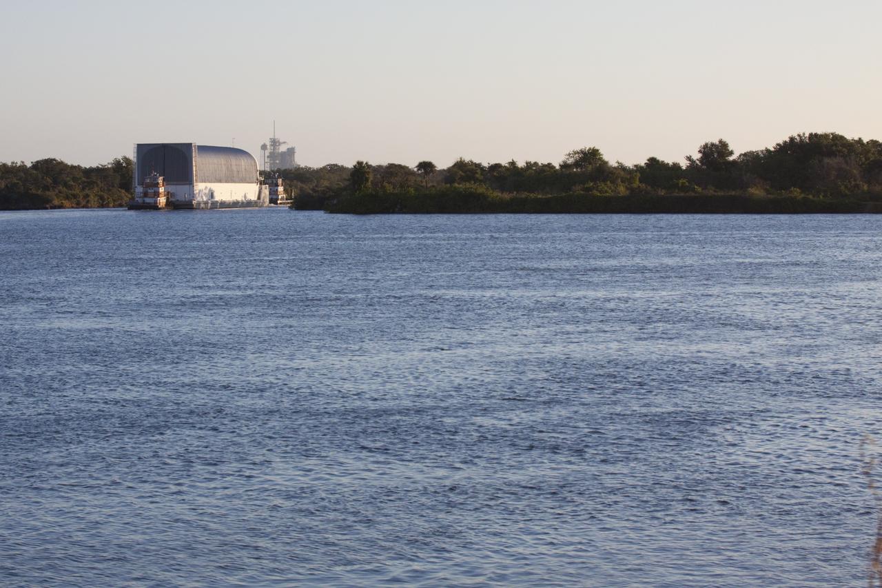 CAPE CANAVERAL, Fla. – Two tugboats move the Pegasus Barge through the Banana River near NASA's Kennedy Space Center in Florida. The 266-foot-long and 50-foot-wide barge will be towed by NASA's Freedom Star ship to deliver space shuttle main engine (SSME) ground support equipment to Stennis Space Center near Bay St. Louis, Miss. Since being delivered to NASA in 1999, Pegasus sailed 41 times and transported 31 shuttle external fuel tanks from Michoud Assembly Facility near New Orleans to Kennedy. To the right of the barge is Launch Pad 39A. The barge is leaving Kennedy, perhaps for the final time. Both the barge and shuttle equipment will remain in storage until their specific future uses are determined. The SSMEs themselves will be transported to Stennis separately for use with the agency’s new heavy-lift rocket, the Space Launch System. The work is part of the Space Shuttle Program’s transition and retirement processing. For more information about Shuttle Transition and Retirement, visit http://www.nasa.gov/mission_pages/transition/home/index.html. Photo credit: NASA/ Kim Shiflett