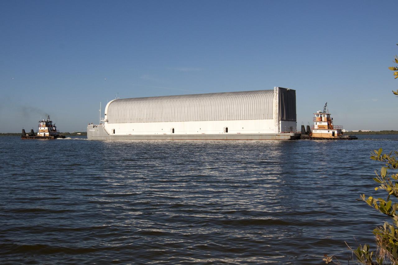 CAPE CANAVERAL, Fla. – Tugboats maneuver the Pegasus Barge through the Banana River after leaving NASA's Kennedy Space Center in Florida. The 266-foot-long and 50-foot-wide barge will be towed by NASA's Freedom Star ship to deliver space shuttle main engine (SSME) ground support equipment to Stennis Space Center near Bay St. Louis, Miss. Since being delivered to NASA in 1999, Pegasus sailed 41 times and transported 31 shuttle external fuel tanks from Michoud Assembly Facility near New Orleans to Kennedy. The barge is leaving Kennedy, perhaps for the final time. Both the barge and shuttle equipment will remain in storage until their specific future uses are determined. The SSMEs themselves will be transported to Stennis separately for use with the agency's new heavy-lift rocket, the Space Launch System. The work is part of the Space Shuttle Program’s transition and retirement processing. For more information about Shuttle Transition and Retirement, visit http://www.nasa.gov/mission_pages/transition/home/index.html. Photo credit: NASA/Kim Shiflett