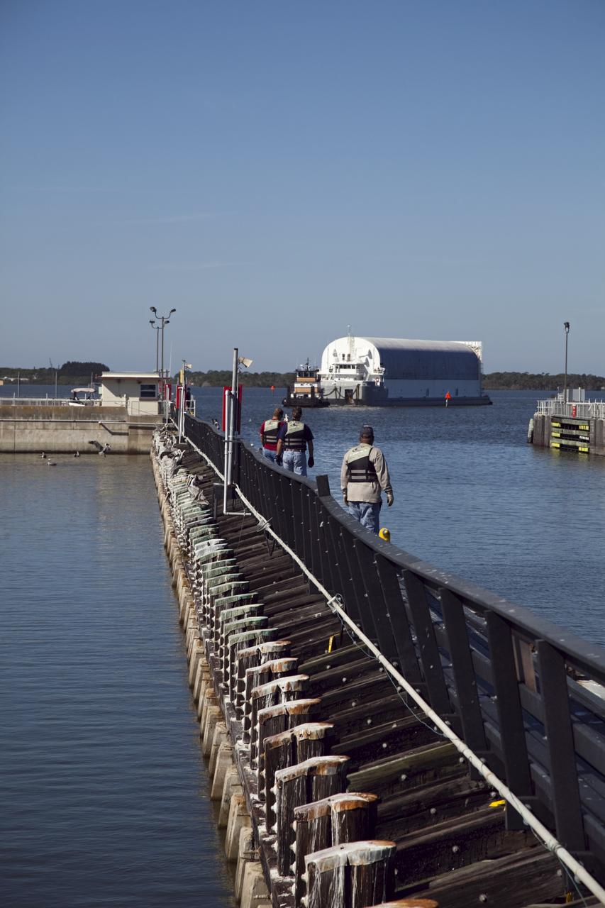 CAPE CANAVERAL, Fla. – Workers are at the ready as tugboats maneuver NASA's Pegasus Barge to the entrance of the Port Canaveral lock in Florida. The 266-foot-long and 50-foot-wide barge will be towed by NASA's Freedom Star ship to deliver space shuttle main engine (SSME) ground support equipment to Stennis Space Center near Bay St. Louis, Miss. Since being delivered to NASA in 1999, Pegasus sailed 41 times and transported 31 shuttle external fuel tanks from Michoud Assembly Facility near New Orleans to Kennedy Space Center. The barge is leaving Kennedy, perhaps for the final time. Both the barge and shuttle equipment will remain in storage until their specific future uses are determined. The SSMEs themselves will be transported to Stennis separately for use with the agency's new heavy-lift rocket, the Space Launch System. The work is part of the Space Shuttle Program’s transition and retirement processing. For more information about Shuttle Transition and Retirement, visit http://www.nasa.gov/mission_pages/transition/home/index.html. Photo credit: NASA/Frankie Martin