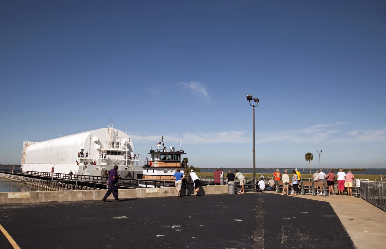 CAPE CANAVERAL, Fla. – Viewers watch from the sidelines as NASA's Pegasus Barge makes its way through the Port Canaveral lock in Florida. The 266-foot-long and 50-foot-wide barge will be towed by NASA's Freedom Star ship to deliver space shuttle main engine (SSME) ground support equipment to Stennis Space Center near Bay St. Louis, Miss. Since being delivered to NASA in 1999, Pegasus sailed 41 times and transported 31 shuttle external fuel tanks from Michoud Assembly Facility near New Orleans to Kennedy Space Center. The barge is leaving Kennedy, perhaps for the final time. Both the barge and shuttle equipment will remain in storage until their specific future uses are determined. The SSMEs themselves will be transported to Stennis separately for use with the agency's new heavy-lift rocket, the Space Launch System. The work is part of the Space Shuttle Program’s transition and retirement processing. For more information about Shuttle Transition and Retirement, visit http://www.nasa.gov/mission_pages/transition/home/index.html. Photo credit: NASA/Frankie Martin