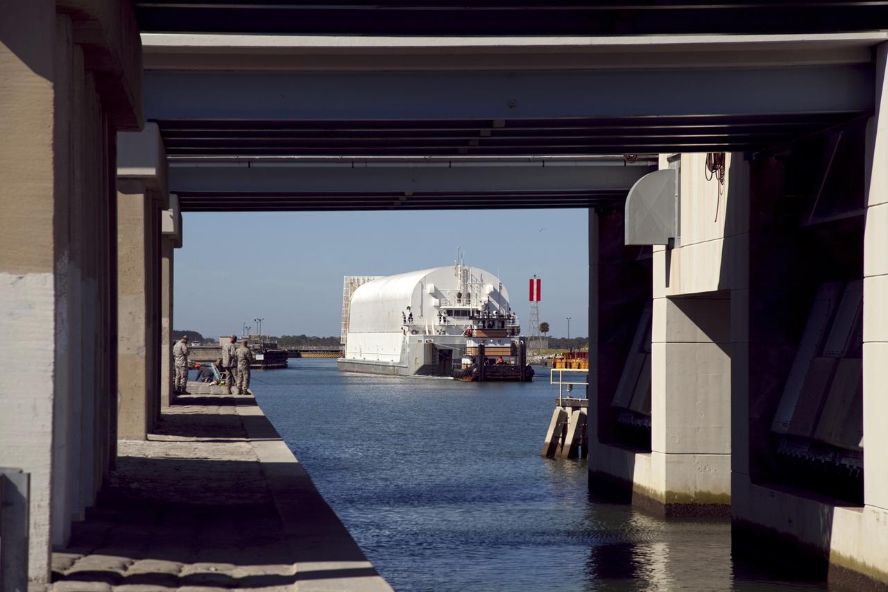 CAPE CANAVERAL, Fla. – The camera captures a unique view of NASA's Pegasus Barge as it is pulled through the Port Canaveral lock in Florida. The 266-foot-long and 50-foot-wide barge will be towed by NASA's Freedom Star ship to deliver space shuttle main engine (SSME) ground support equipment to Stennis Space Center near Bay St. Louis, Miss. Since being delivered to NASA in 1999, Pegasus sailed 41 times and transported 31 shuttle external fuel tanks from Michoud Assembly Facility near New Orleans to Kennedy Space Center. The barge is leaving Kennedy, perhaps for the final time. Both the barge and shuttle equipment will remain in storage until their specific future uses are determined. The SSMEs themselves will be transported to Stennis separately for use with the agency's new heavy-lift rocket, the Space Launch System. The work is part of the Space Shuttle Program’s transition and retirement processing. For more information about Shuttle Transition and Retirement, visit http://www.nasa.gov/mission_pages/transition/home/index.html. Photo credit: NASA/Frankie Martin