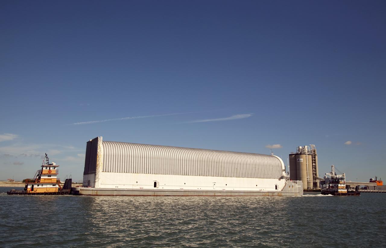 CAPE CANAVERAL, Fla. – Tugboats maneuver the Pegasus Barge through Port Canaveral after leaving NASA's Kennedy Space Center in Florida. The 266-foot-long and 50-foot-wide barge will be towed by NASA's Freedom Star ship to deliver space shuttle main engine (SSME) ground support equipment to Stennis Space Center near Bay St. Louis, Miss. Since being delivered to NASA in 1999, Pegasus sailed 41 times and transported 31 shuttle external fuel tanks from Michoud Assembly Facility near New Orleans to Kennedy. The barge is leaving Kennedy, perhaps for the final time. Both the barge and shuttle equipment will remain in storage until their specific future uses are determined. The SSMEs themselves will be transported to Stennis separately for use with the agency's new heavy-lift rocket, the Space Launch System. The work is part of the Space Shuttle Program’s transition and retirement processing. For more information about Shuttle Transition and Retirement, visit http://www.nasa.gov/mission_pages/transition/home/index.html. Photo credit: NASA/Frankie Martin