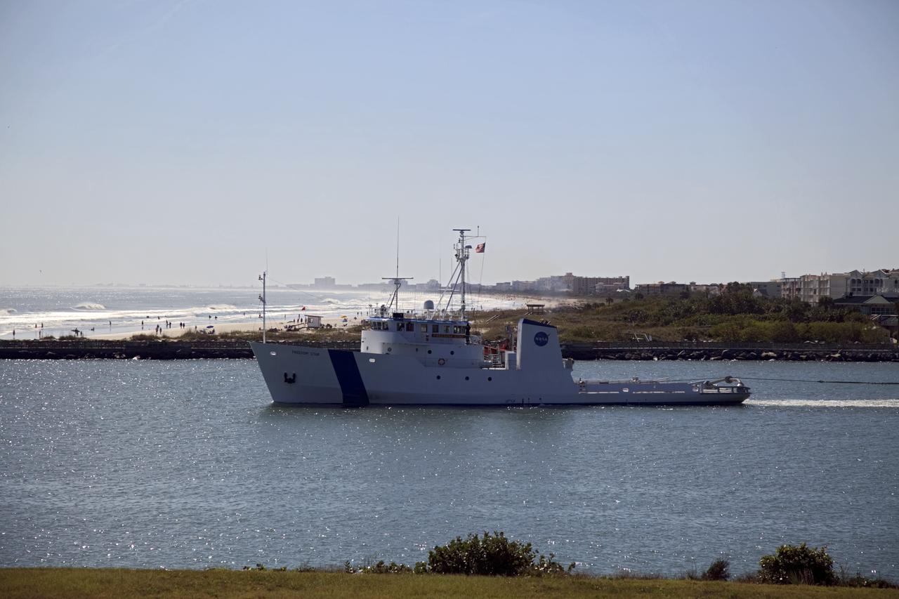 CAPE CANAVERAL, Fla. – NASA's Freedom Star ship nears the Atlantic Ocean as it tows the Pegasus Barge through Port Canaveral in Florida. Freedom Star is towing the 266-foot-long and 50-foot-wide barge to Stennis Space Center near Bay St. Louis, Miss. to deliver space shuttle main engine (SSME) ground support equipment. Since being delivered to NASA in 1999, Pegasus sailed 41 times and transported 31 shuttle external fuel tanks from Michoud Assembly Facility near New Orleans to Kennedy Space Center. The barge is leaving Kennedy, perhaps for the final time. Both the barge and shuttle equipment will remain in storage until their specific future uses are determined. The SSMEs themselves will be transported to Stennis separately for use with the agency's new heavy-lift rocket, the Space Launch System. The work is part of the Space Shuttle Program’s transition and retirement processing. For more information about Shuttle Transition and Retirement, visit http://www.nasa.gov/mission_pages/transition/home/index.html. Photo credit: NASA/Frankie Martin