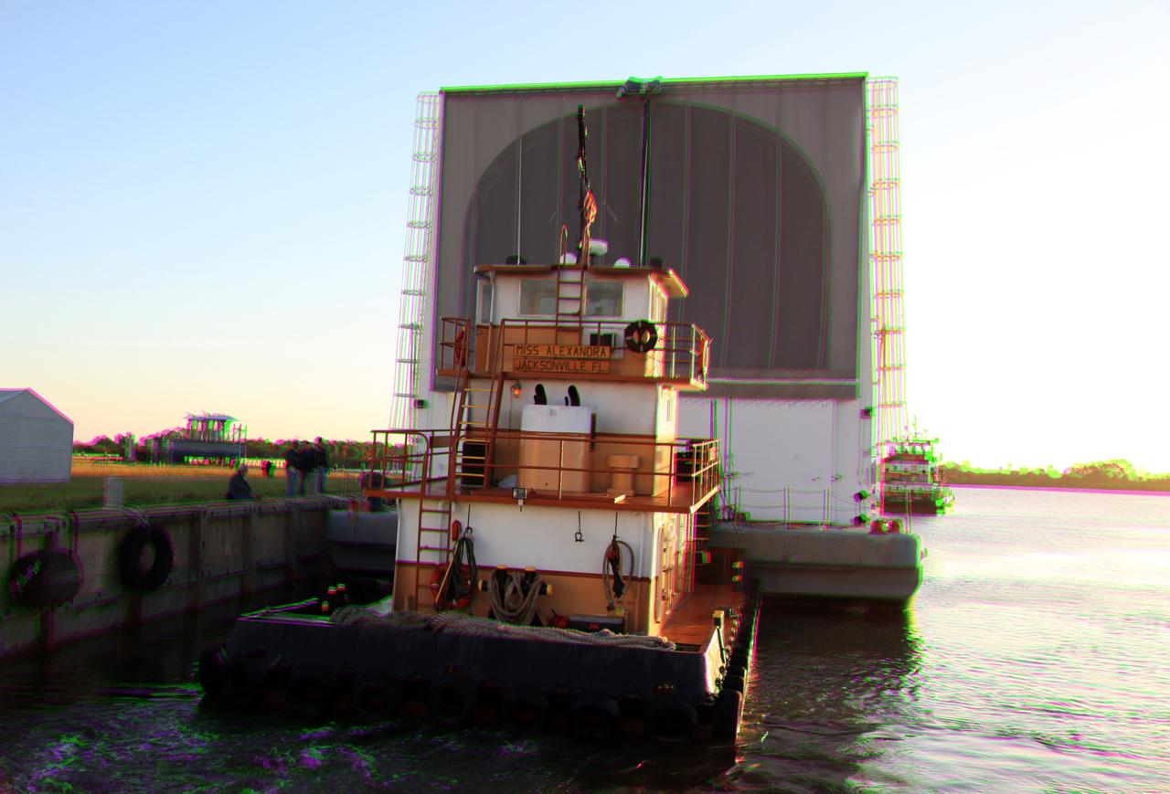 CAPE CANAVERAL, Fla. –This 3-D image shows the tugboat, Miss Alexandra, beginning to push the Pegasus Barge away from the dock at the Turn Basin in the Launch Complex 39 area at NASA's Kennedy Space Center in Florida. The 266-foot-long and 50-foot-wide barge will be towed by NASA's Freedom Star ship to deliver space shuttle main engine (SSME) ground support equipment to Stennis Space Center near Bay St. Louis, Miss. Since being delivered to NASA in 1999, Pegasus sailed 41 times and transported 31 shuttle external fuel tanks from Michoud Assembly Facility near New Orleans to Kennedy. To view this image, use green and magenta 3-D glasses. The barge is leaving Kennedy, perhaps for the final time. Both the barge and shuttle equipment will remain in storage until their specific future uses are determined. The SSMEs themselves will be transported to Stennis separately for use with the agency's new heavy-lift rocket, the Space Launch System. The work is part of the Space Shuttle Program’s transition and retirement processing. For more information about Shuttle Transition and Retirement, visit http://www.nasa.gov/mission_pages/transition/home/index.html. Photo credit: NASA/Frankie Martin