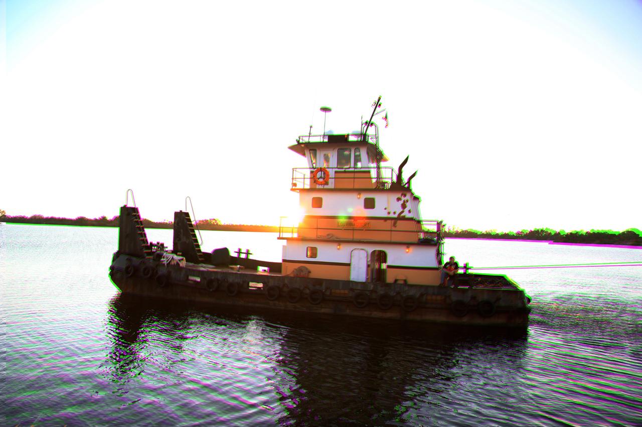CAPE CANAVERAL, Fla. –This 3-D image shows a tugboat pulling the Pegasus Barge along the Banana River after leaving NASA's Kennedy Space Center in Florida. The 266-foot-long and 50-foot-wide barge will be towed by NASA's Freedom Star ship to deliver space shuttle main engine (SSME) ground support equipment to Stennis Space Center near Bay St. Louis, Miss. Since being delivered to NASA in 1999, Pegasus sailed 41 times and transported 31 shuttle external fuel tanks from Michoud Assembly Facility near New Orleans to Kennedy. To view this image, use green and magenta 3-D glasses. The barge is leaving Kennedy, perhaps for the final time. Both the barge and shuttle equipment will remain in storage until their specific future uses are determined. The SSMEs themselves will be transported to Stennis separately for use with the agency's new heavy-lift rocket, the Space Launch System. The work is part of the Space Shuttle Program’s transition and retirement processing. For more information about Shuttle Transition and Retirement, visit http://www.nasa.gov/mission_pages/transition/home/index.html. Photo credit: NASA/Frankie Martin
