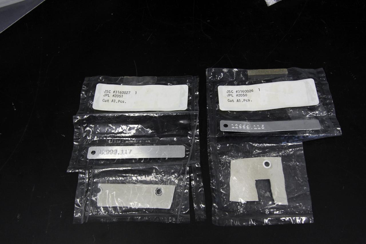 CAPE CANAVERAL, Fla. – In the Granular Mechanics and Regolith Operations (GMRO) Lab at NASA's Kennedy Space Center in Florida, pieces of the Surveyor 3 spacecraft returned from the lunar surface on the Apollo 12 mission are available for examination by the lab's staff.    The GMRO Lab is one of several labs located in NASA's Space Life Sciences Laboratory (SLSL) facility. The lab is staffed by three physicists, six mechanical or aerospace engineers and several technicians who are studying how the rocket exhaust of landing vehicles affects lunar and Martian science missions, including the sandblasting of instruments with soil and dust ejecta and the disturbance or contamination of soil beneath the lander.  For more information on the GMRO Lab, see p. 7 of the Spaceport News dated Nov. 11, 2011, at http://www.nasa.gov/centers/kennedy/pdf/603285main_nov11-2011.pdf.  Photo credit: NASA/Jim Grossmann