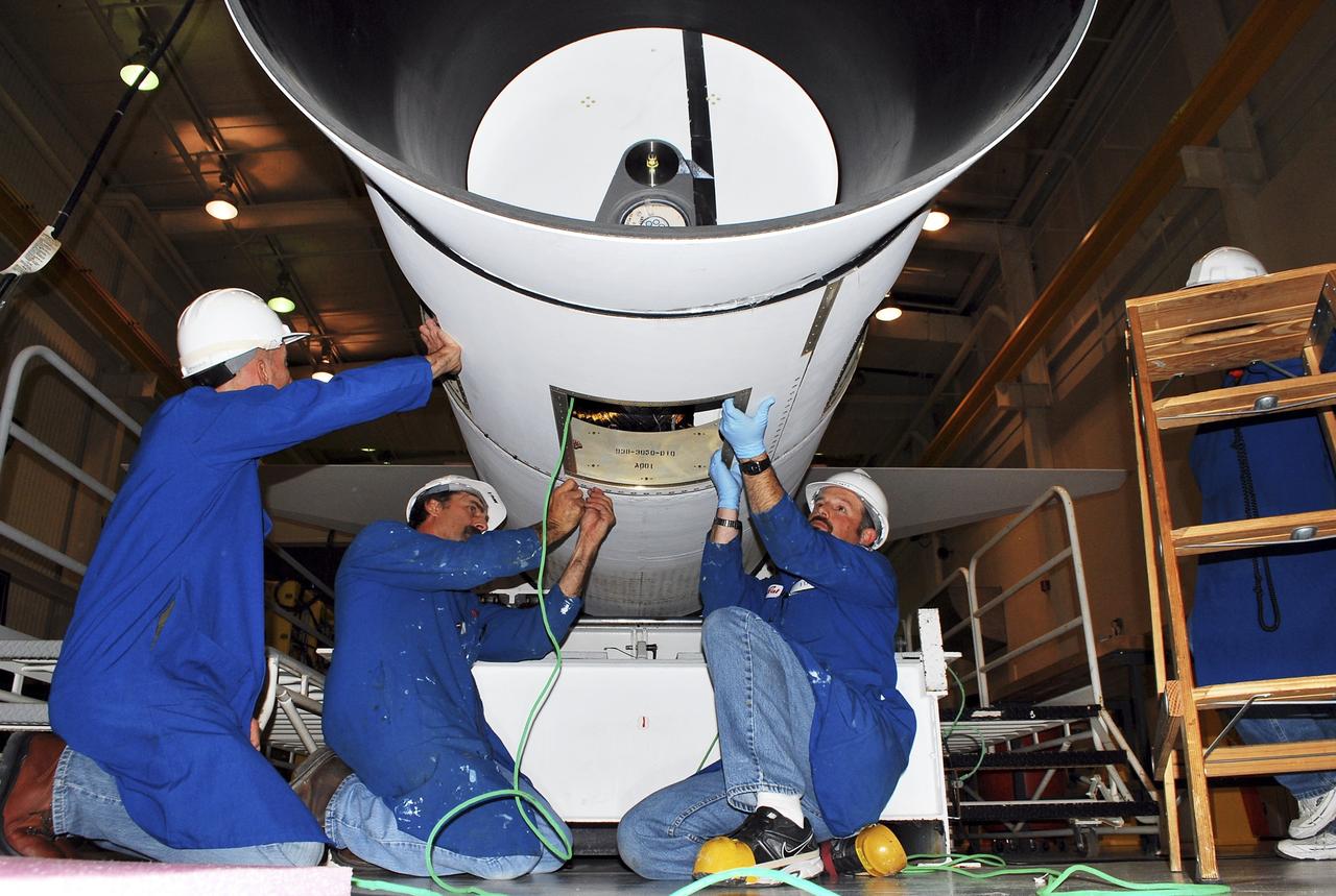 VANDENBERG AIR FORCE BASE, Calif. -- At a Pegasus booster processing facility at Vandenberg Air Force Base in California, technicians complete the final installation of the aft skirt on the first stage of the Pegasus XL rocket.     The Orbital Sciences Corp. Pegasus rocket will launch the Nuclear Spectroscopic Telescope Array (NuSTAR) into space. After the rocket and spacecraft are processed at Vandenberg, they will be flown on the Orbital Sciences’ L-1011 carrier aircraft to the Ronald Reagan Ballistic Missile Defense Test Site at the Pacific Ocean’s Kwajalein Atoll for launch. The high-energy x-ray telescope will conduct a census for black holes, map radioactive material in young supernovae remnants, and study the origins of cosmic rays and the extreme physics around collapsed stars. For more information, visit science.nasa.gov/missions/nustar/. Photo credit: NASA/Randy Beaudoin, VAFB
