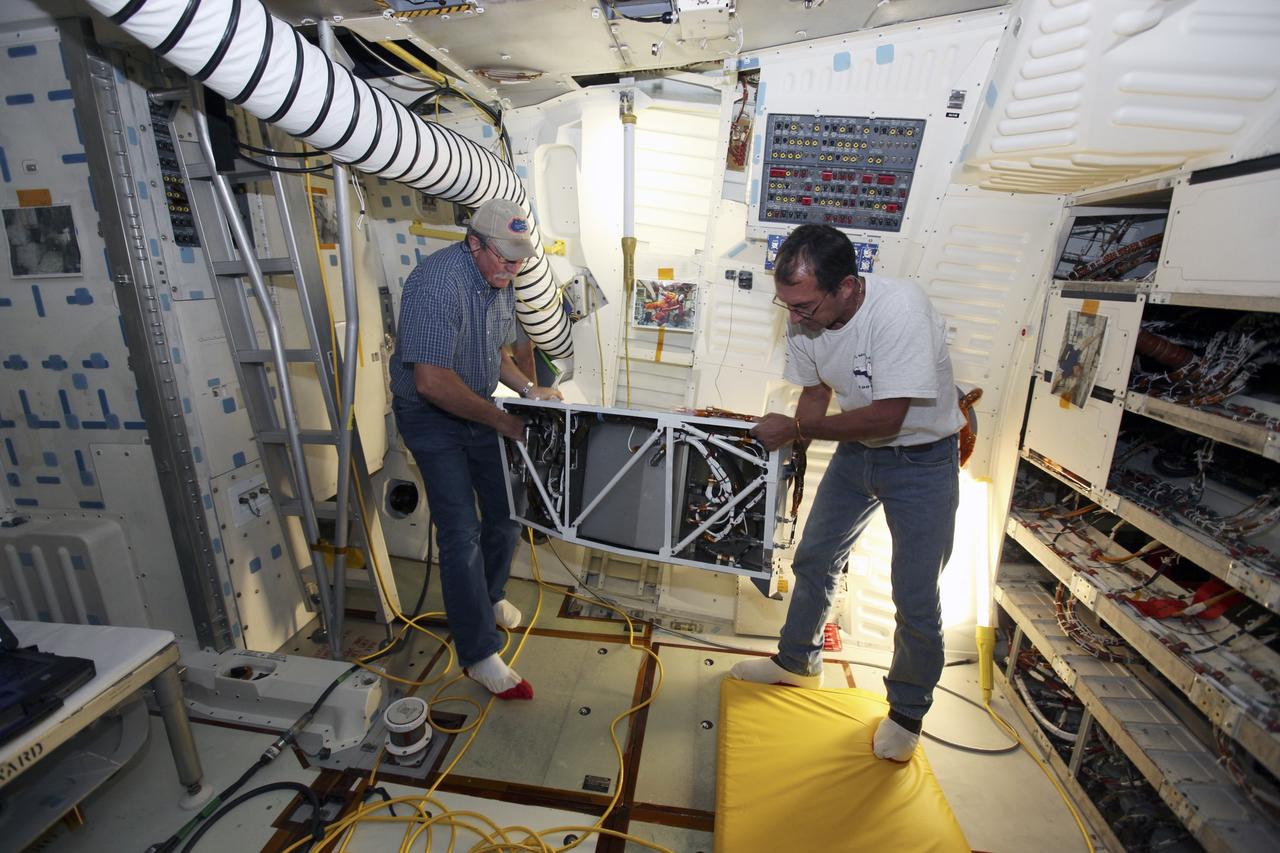 CAPE CANAVERAL, Fla. – Inside Orbiter Processing Facility-1 at NASA’s Kennedy Space Center in Florida, technicians prepare to install the shuttle orbiter repackaged galley (SORG) in the middeck of space shuttle Discovery. After Discovery’s final mission, STS-133, the SORG was removed and sent to a United Space Alliance lab in Houston where it was cleaned and deserviced. Water in the microbial check valve and the orbiter water system was drained and dried. The SORG was returned to Kennedy Space Center. The work is part of the Space Shuttle Program’s transition and retirement processing of shuttle Discovery, which is being prepared for display at Smithsonian’s National Air and Space Museum, Steven F. Udvar-Hazy Center in Chantilly, Va. For more information, visit http://www.nasa.gov/shuttle. Photo credit: NASA/Dimitri Gerondidakis