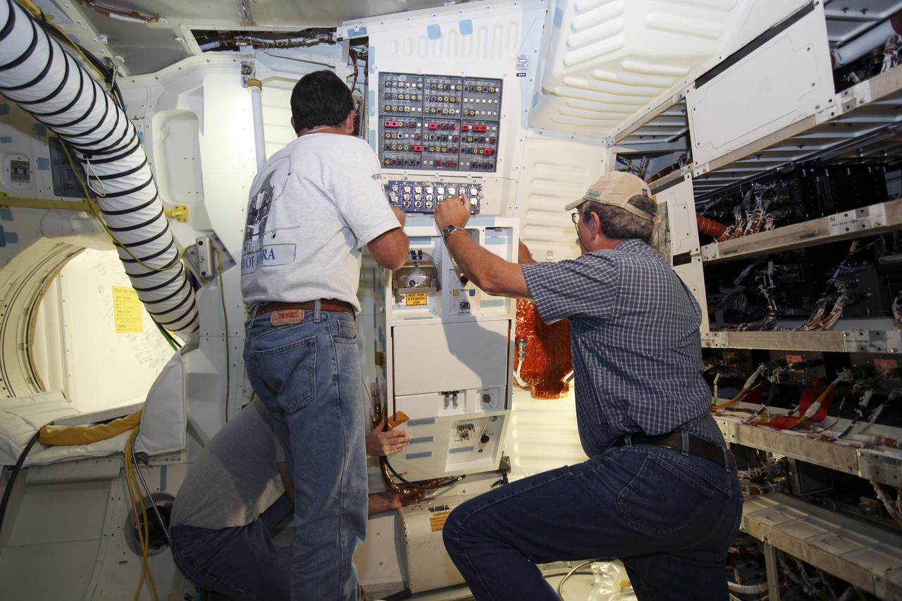 CAPE CANAVERAL, Fla. – Inside Orbiter Processing Facility-1 at NASA’s Kennedy Space Center in Florida, technicians install the shuttle orbiter repackaged galley (SORG) in the middeck of space shuttle Discovery. After Discovery’s final mission, STS-133, the SORG was removed and sent to a United Space Alliance lab in Houston where it was cleaned and deserviced. Water in the microbial check valve and the orbiter water system was drained and dried. The SORG was returned to Kennedy Space Center. The work is part of the Space Shuttle Program’s transition and retirement processing of shuttle Discovery, which is being prepared for display at Smithsonian’s National Air and Space Museum, Steven F. Udvar-Hazy Center in Chantilly, Va. For more information, visit http://www.nasa.gov/shuttle. Photo credit: NASA/Dimitri Gerondidakis