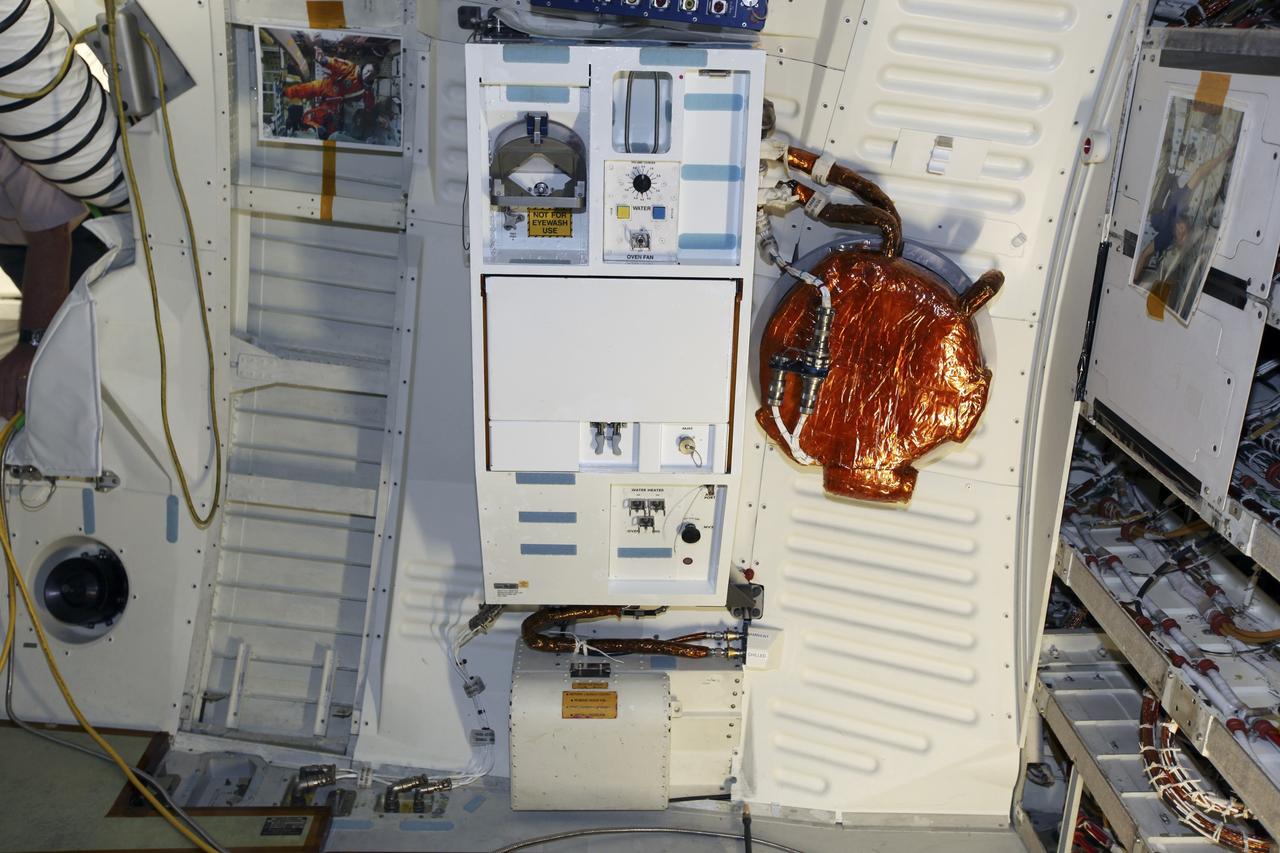 CAPE CANAVERAL, Fla. – Inside Orbiter Processing Facility-1 at NASA’s Kennedy Space Center in Florida, the shuttle orbiter repackaged galley (SORG) is installed in the middeck of space shuttle Discovery. After Discovery’s final mission, STS-133, the SORG was removed and sent to a United Space Alliance lab in Houston where it was cleaned and deserviced. Water in the microbial check valve and the orbiter water system was drained and dried. The SORG was returned to Kennedy Space Center. The work is part of the Space Shuttle Program’s transition and retirement processing of shuttle Discovery, which is being prepared for display at Smithsonian’s National Air and Space Museum, Steven F. Udvar-Hazy Center in Chantilly, Va. For more information, visit http://www.nasa.gov/shuttle. Photo credit: NASA/Dimitri Gerondidakis