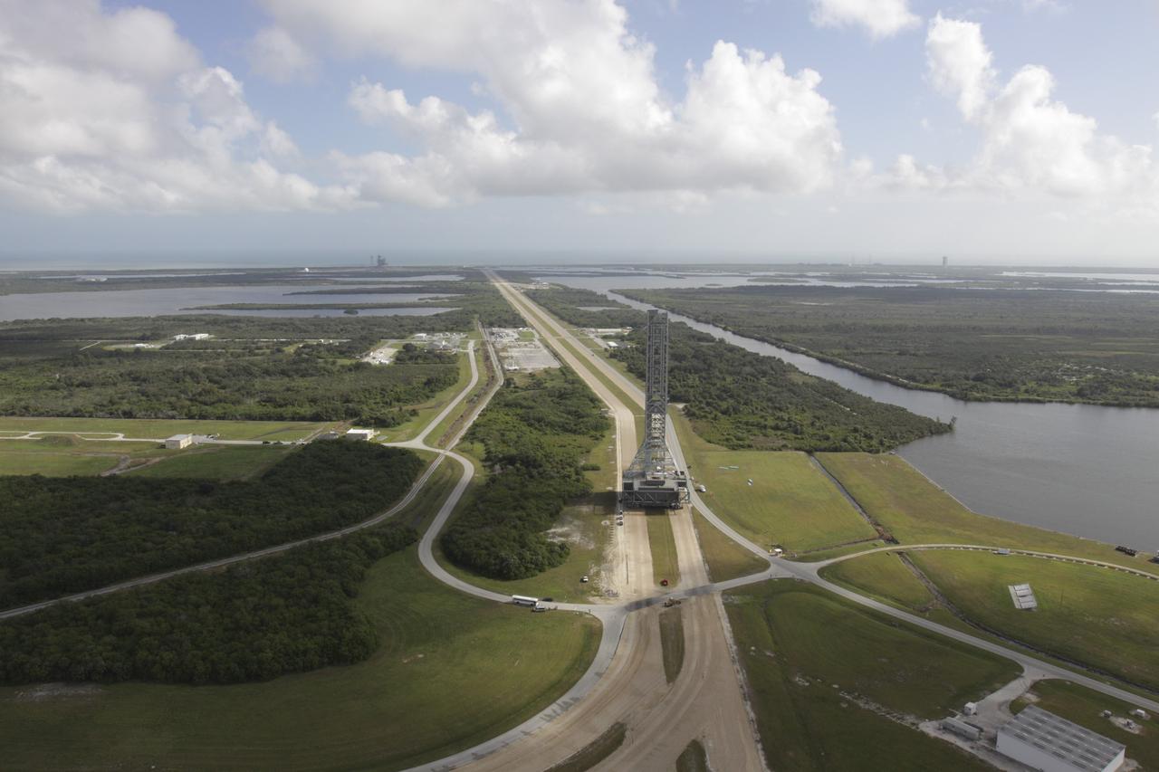 CAPE CANAVERAL, Fla. – On the crawlerway at NASA's Kennedy Space Center in Florida, an aerial view shows the mobile launcher (ML) as it rolls out aboard the crawler-transporter moving from next to Kennedy's Vehicle Assembly Building to Launch Pad 39B, a distance of 4.2 miles. Data on the ML will be collected from structural and functional engineering tests and used for the next phases of construction. The 355-foot-tall ML structure, which took about two years to construct, is being modified to support NASA’s Space Launch System (SLS), the heavy-lift rocket that will launch astronauts farther into space than ever before. SLS will also create high-quality jobs here at home, and provide the cornerstone for America's future human space exploration efforts. Photo credit: NASA/Kim Shiflett