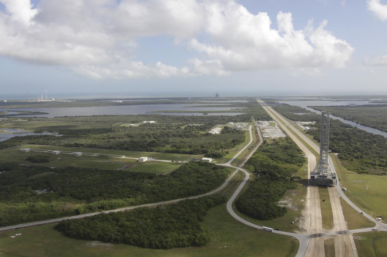 CAPE CANAVERAL, Fla. – On the crawlerway at NASA's Kennedy Space Center in Florida, an aerial view shows the mobile launcher (ML) as it rolls out aboard the crawler-transporter moving from next to Kennedy's Vehicle Assembly Building to Launch Pad 39B, a distance of 4.2 miles. Data on the ML will be collected from structural and functional engineering tests and used for the next phases of construction. The 355-foot-tall ML structure, which took about two years to construct, is being modified to support NASA’s Space Launch System (SLS), the heavy-lift rocket that will launch astronauts farther into space than ever before. SLS will also create high-quality jobs here at home, and provide the cornerstone for America's future human space exploration efforts. Photo credit: NASA/Kim Shiflett