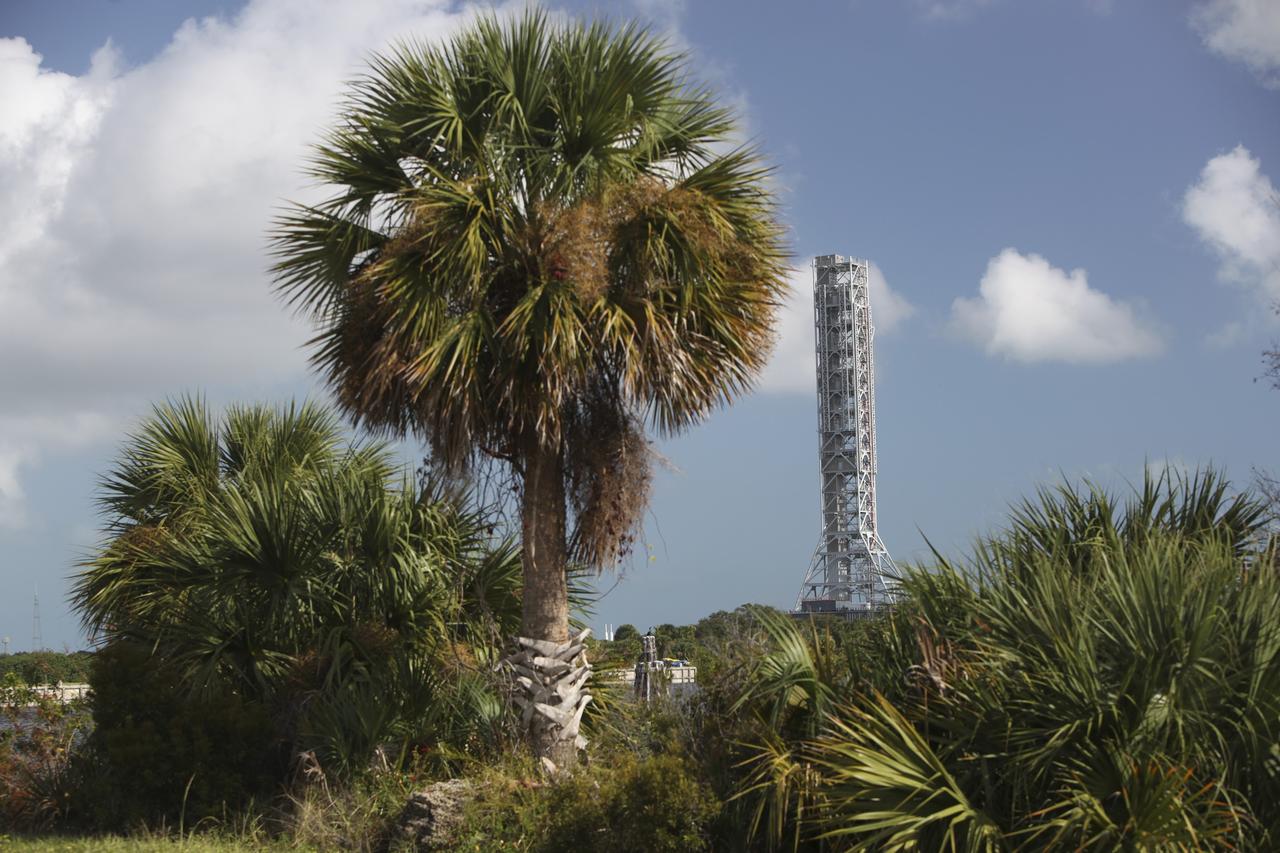CAPE CANAVERAL, Fla. – The natural vegetation at NASA's Kennedy Space Center in Florida frames the Mobile Launcher (ML) as it rolls out aboard a crawler-transporter from next to Kennedy's Vehicle Assembly Building to Launch Pad 39B, a distance of 4.2 miles. Data on the ML will be collected from structural and functional engineering tests and used for the next phases of construction. The 355-foot-tall ML structure, which took about two years to construct, is being modified to support NASA’s Space Launch System (SLS), the heavy-lift rocket that will launch astronauts farther into space than ever before. SLS will also create high-quality jobs here at home, and provide the cornerstone for America's future human space exploration efforts. Photo credit: NASA/Dimitri Gerondidakis