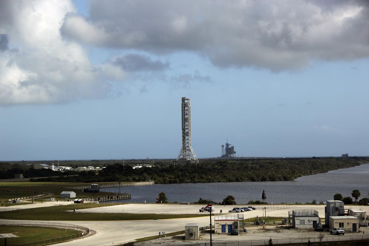 CAPE CANAVERAL, Fla. – At NASA's Kennedy Space Center in Florida, an aerial view shows the mobile launcher (ML) as it rolls out aboard the crawler-transporter moving from next to Kennedy's Vehicle Assembly Building to Launch Pad 39B, a distance of 4.2 miles. Data on the ML will be collected from structural and functional engineering tests and used for the next phases of construction. In the distance is Launch Pad 39A. The 355-foot-tall ML structure, which took about two years to construct, is being modified to support NASA’s Space Launch System (SLS), the heavy-lift rocket that will launch astronauts farther into space than ever before. SLS will also create high-quality jobs here at home, and provide the cornerstone for America's future human space exploration efforts. Photo credit: NASA/Dimitri Gerondidakis