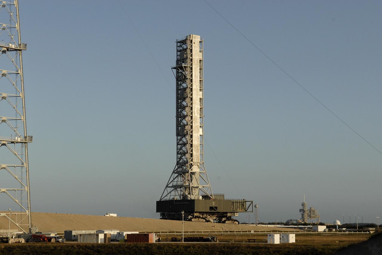 CAPE CANAVERAL, Fla. – At NASA’s Kennedy Space Center in Florida, the mobile launcher (ML) is nearing completion of its 4.2-mile journey to Launch Pad 39B. The launcher rolled out aboard a crawler-transporter from next to Kennedy's Vehicle Assembly Building to the pad at about 9:15 a.m. EST. Data on the ML will be collected from structural and functional engineering tests and used for the next phases of construction overseen by NASA’s 21st Century Ground Systems Program. To the right in the background is Launch Pad 39A. The 355-foot-tall ML structure, which took about two years to construct, is being modified to support NASA’s Space Launch System (SLS), the heavy-lift rocket that will launch astronauts farther into space than ever before. SLS will also create high-quality jobs here at home, and provide the cornerstone for America's future human space exploration efforts. Photo credit: NASA/Charisse Nahser