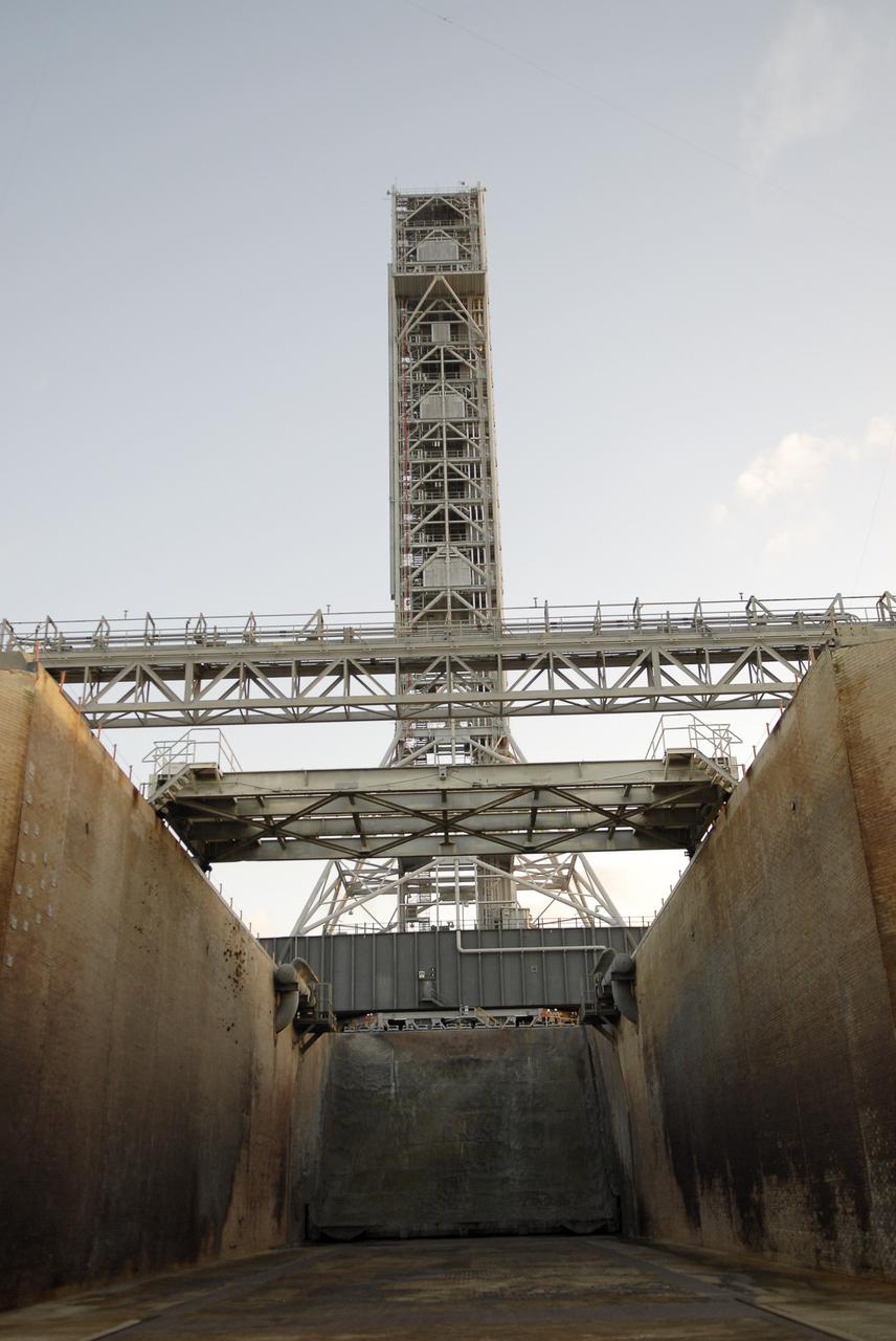 CAPE CANAVERAL, Fla. – At NASA’s Kennedy Space Center in Florida, taken from inside the flame trench, the camera captures a unique view of the mobile launcher (ML) as it nears completion of its 4.2-mile journey to Launch Pad 39B. The launcher rolled out aboard a crawler-transporter from next to Kennedy's Vehicle Assembly Building to the pad at about 9:15 a.m. EST. Data on the ML will be collected from structural and functional engineering tests and used for the next phases of construction overseen by NASA’s 21st Century Ground Systems Program. The 355-foot-tall ML structure, which took about two years to construct, is being modified to support NASA’s Space Launch System (SLS), the heavy-lift rocket that will launch astronauts farther into space than ever before. SLS will also create high-quality jobs here at home, and provide the cornerstone for America's future human space exploration efforts. Photo credit: NASA/Charisse Nahser