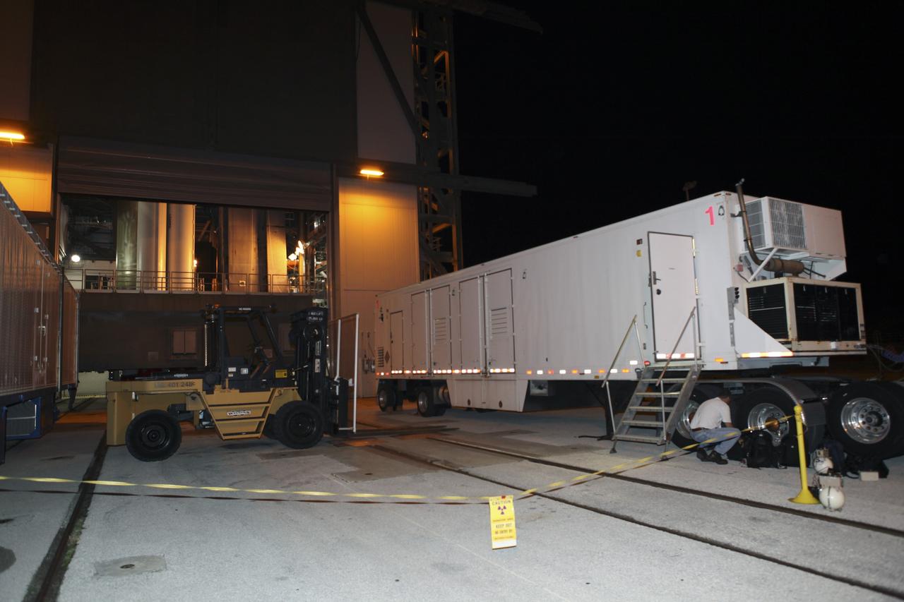 CAPE CANAVERAL, Fla. -- Outside the Vertical Integration Facility at Space Launch Complex 41, an area has been cordoned off beside the trailer which has arrived at the pad carrying the multi-mission radioisotope thermoelectric generator (MMRTG) for NASA's Mars Science Laboratory (MSL) mission. The generator will be lifted up to the top of the rocket and installed on the MSL spacecraft, encapsulated within the payload fairing.    The MMRTG will generate the power needed for the mission from the natural decay of plutonium-238, a non-weapons-grade form of the radioisotope. Heat produced by this natural decay will provide constant power through the day and night during all seasons. MSL's components include a car-sized rover, Curiosity, which has 10 science instruments designed to search for signs of life, including methane, and help determine if the gas is from a biological or geological source. Heat emitted by the MMRTG will be circulated throughout the rover system to keep instruments, computers, mechanical devices and communications systems within their operating temperature ranges. Launch of MSL aboard a United Launch Alliance Atlas V rocket is targeted for Nov. 25 from Space Launch Complex 41 on Cape Canaveral Air Force Station. For more information, visit http://www.nasa.gov/msl. Photo credit: NASA/Dimitri Gerondidakis