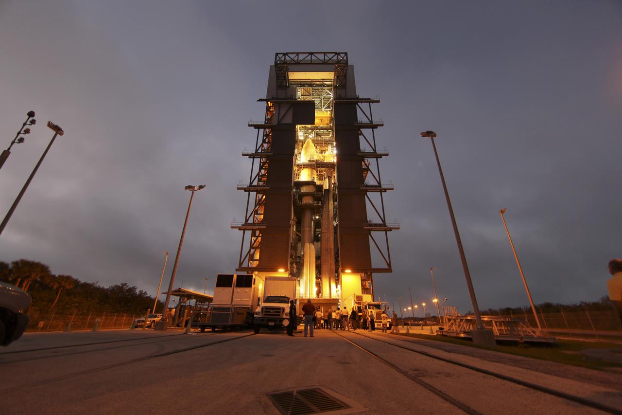 CAPE CANAVERAL, Fla. -- The Atlas V rocket set to launch NASA's Mars Science Laboratory (MSL) mission is illuminated inside the Vertical Integration Facility at Space Launch Complex 41, where employees have gathered to hoist the spacecraft's multi-mission radioisotope thermoelectric generator (MMRTG). The generator will be lifted up to the top of the rocket and installed on the MSL spacecraft, encapsulated within the payload fairing.    The MMRTG will generate the power needed for the mission from the natural decay of plutonium-238, a non-weapons-grade form of the radioisotope. Heat produced by this natural decay will provide constant power through the day and night during all seasons. MSL's components include a car-sized rover, Curiosity, which has 10 science instruments designed to search for signs of life, including methane, and help determine if the gas is from a biological or geological source. Heat emitted by the MMRTG will be circulated throughout the rover system to keep instruments, computers, mechanical devices and communications systems within their operating temperature ranges. Launch of MSL aboard a United Launch Alliance Atlas V rocket is targeted for Nov. 25 from Space Launch Complex 41 on Cape Canaveral Air Force Station. For more information, visit http://www.nasa.gov/msl. Photo credit: NASA/Dimitri Gerondidakis