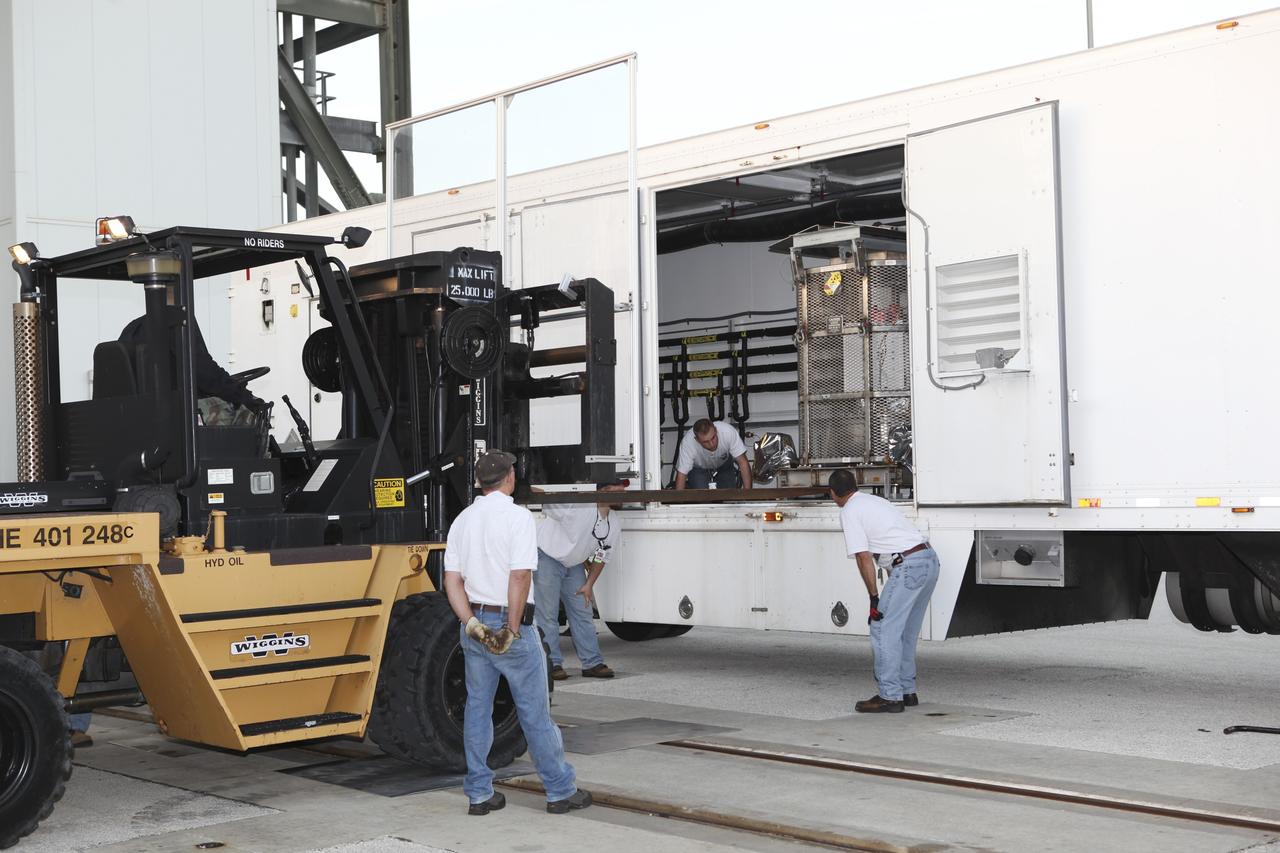 CAPE CANAVERAL, Fla. -- The multi-mission radioisotope thermoelectric generator (MMRTG) for NASA's Mars Science Laboratory (MSL) mission, enclosed in the mesh container known as the "gorilla cage," is about to emerge from its trailer outside the Vertical Integration Facility at Space Launch Complex 41. The generator will be lifted up to the top of the rocket and installed on the MSL spacecraft, encapsulated within the payload fairing.    The MMRTG will generate the power needed for the mission from the natural decay of plutonium-238, a non-weapons-grade form of the radioisotope. Heat produced by this natural decay will provide constant power through the day and night during all seasons. MSL's components include a car-sized rover, Curiosity, which has 10 science instruments designed to search for signs of life, including methane, and help determine if the gas is from a biological or geological source. Heat emitted by the MMRTG will be circulated throughout the rover system to keep instruments, computers, mechanical devices and communications systems within their operating temperature ranges. Launch of MSL aboard a United Launch Alliance Atlas V rocket is targeted for Nov. 25 from Space Launch Complex 41 on Cape Canaveral Air Force Station. For more information, visit http://www.nasa.gov/msl. Photo credit: NASA/Dimitri Gerondidakis